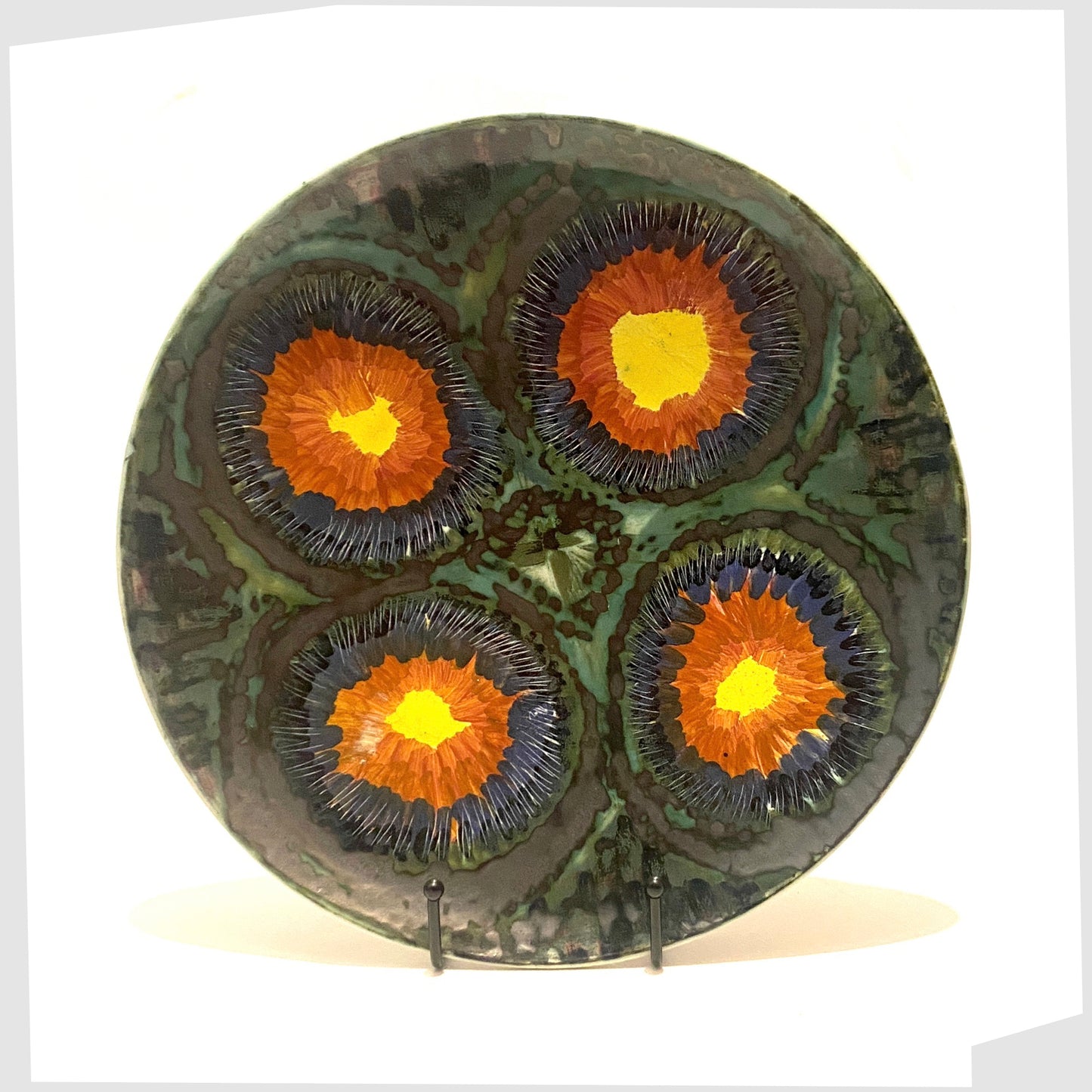 circle charger plate by iden pottery rye, in yellow, red, and sea green glazing, with fluid matte plate glazing