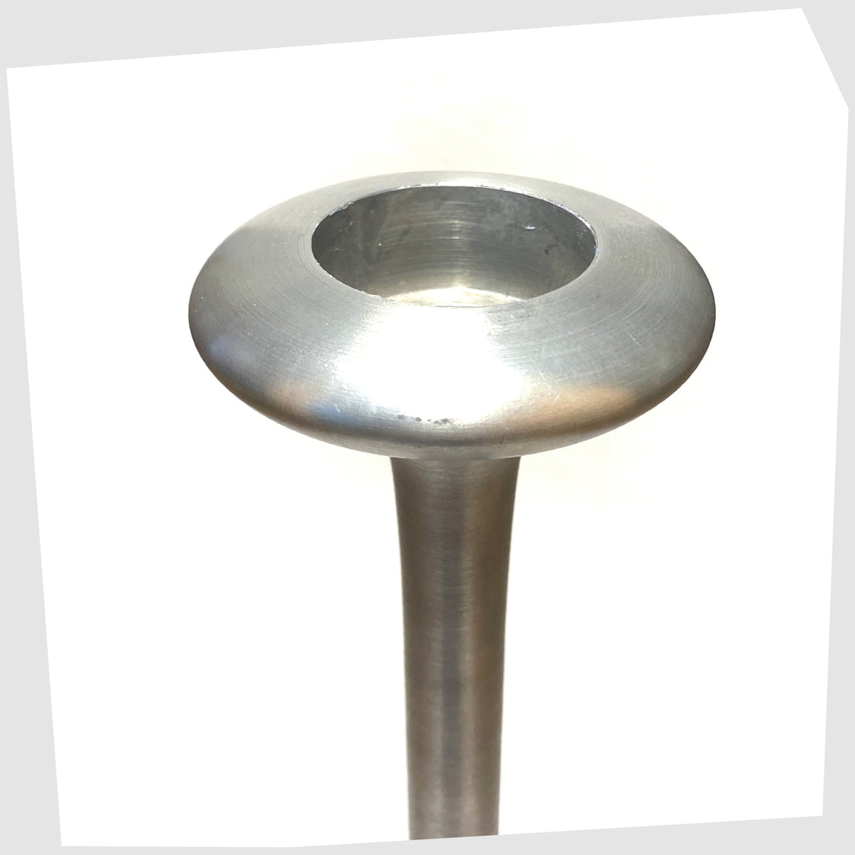 Top of the Ikea Kagla Candleholder made of brushed aluminium, shown on a white background