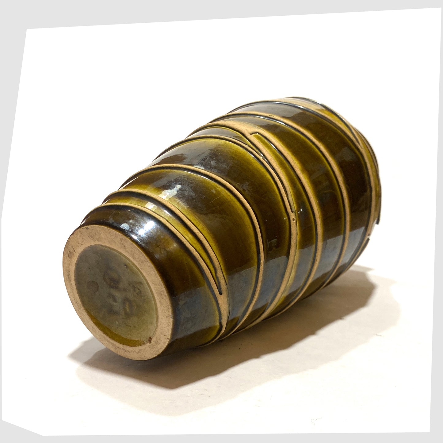 Base of the Ilkra Keramik 5/20 Vase finished in a rich green glaze with contrasting lines of matte clay, shown on a white background