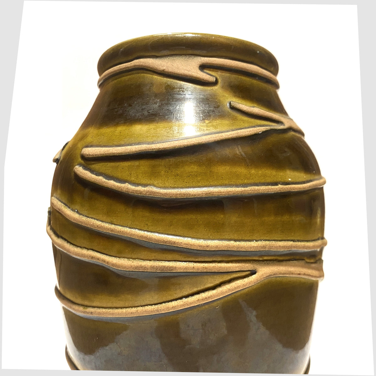 Close up of the Ilkra Keramik 5/20 Vase finished in a rich green glaze with contrasting lines of matte clay, shown on a white background