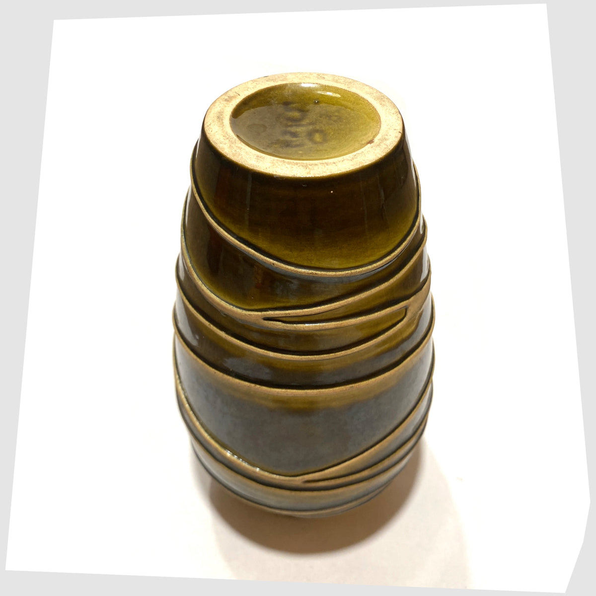 Base of the Ilkra Keramik 5/20 Vase finished in a rich green glaze with contrasting lines of matte clay, marked as model 5/20, shown on a white background