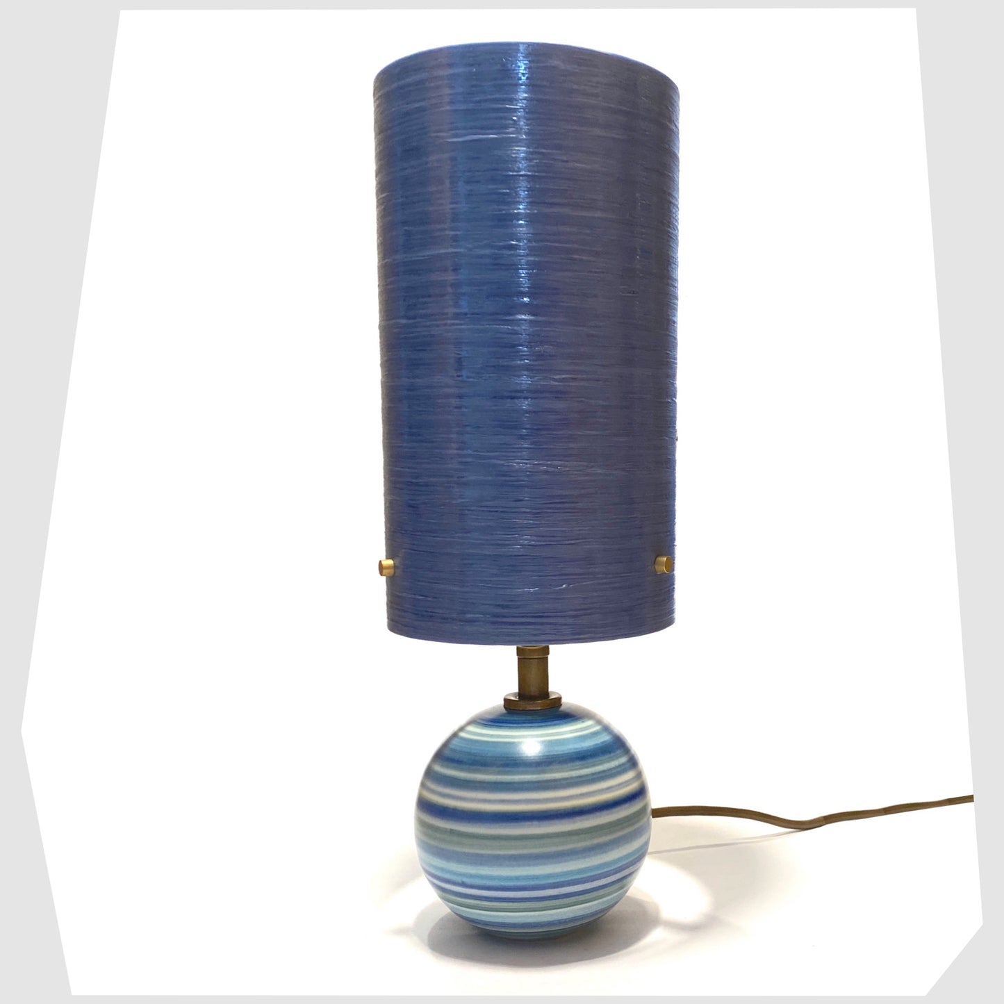 Hand-painted Jersey Pottery Spherical Table Lamp with a blue spun fibreglass lampshade, shown on a white background