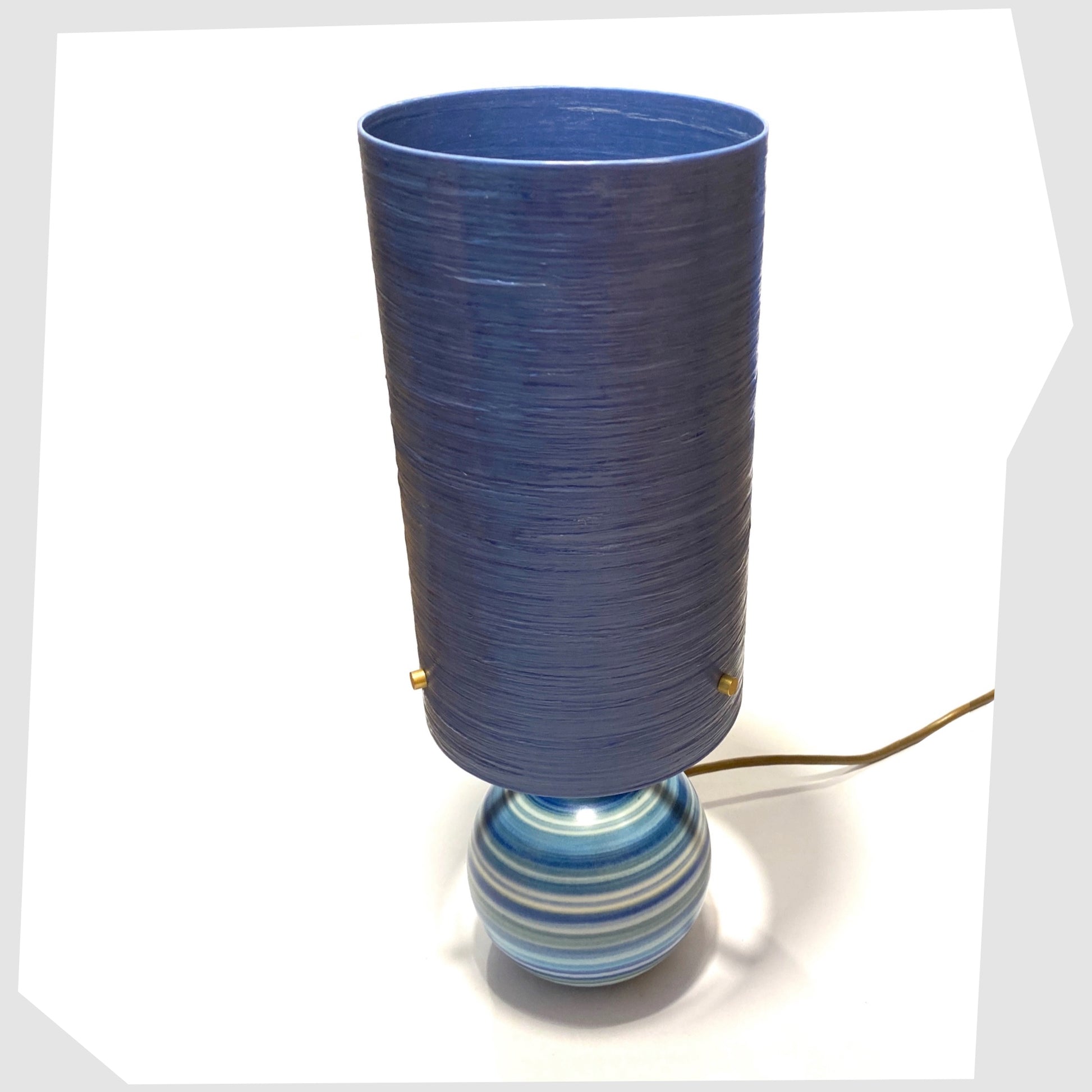 Top view of the hand-painted Jersey Pottery Spherical Table Lamp with a blue spun fibreglass lampshade, shown on a white background