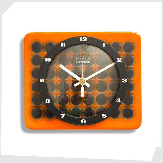 kienzle boutique ceramic wall clock in vivid orange glaze with geometric circular pattern, with white hands