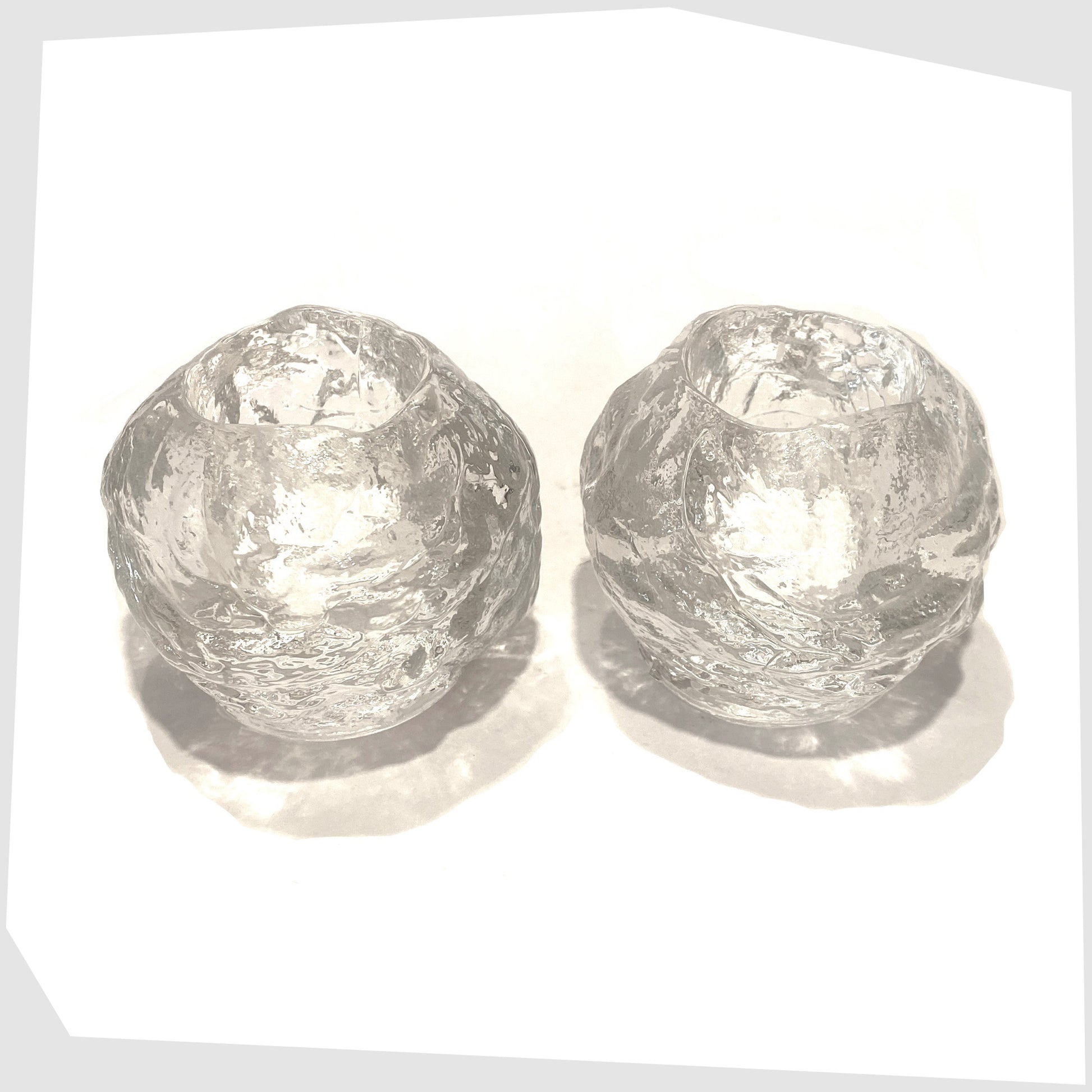 top of the Pair of Kosta Boda Snowball Tealight holders, made in clear textured glass