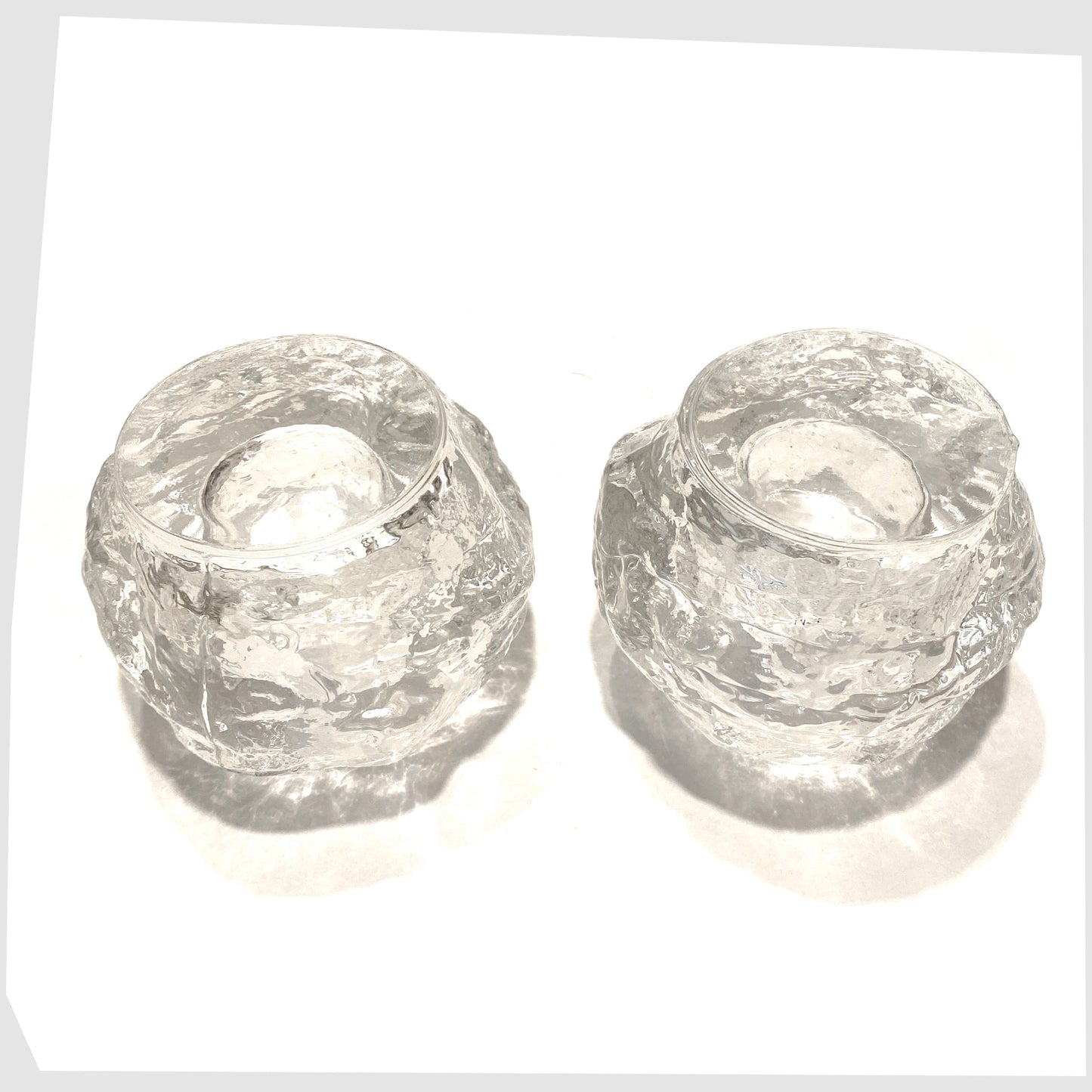 Base of the pair of Kosta Boda Snowball Tealight holders, made in clear textured glass