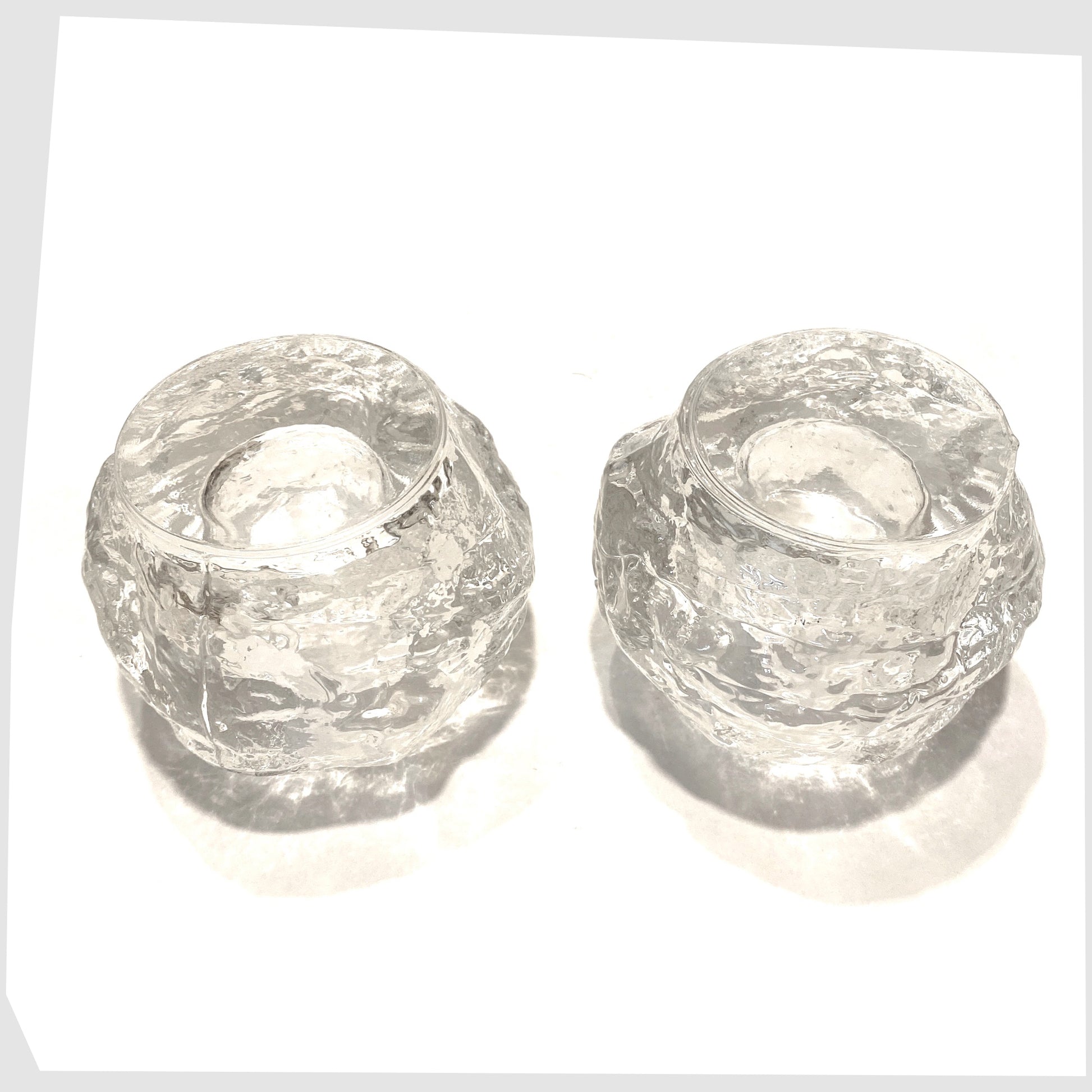 Base of the pair of Kosta Boda Snowball Tealight holders, made in clear textured glass