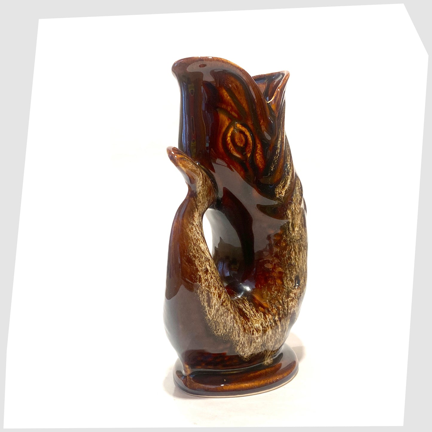 Tail of the Fosters Studio Pottery Glugglr Jug in a chestnut brown with amber drip glaze, shown on a white background