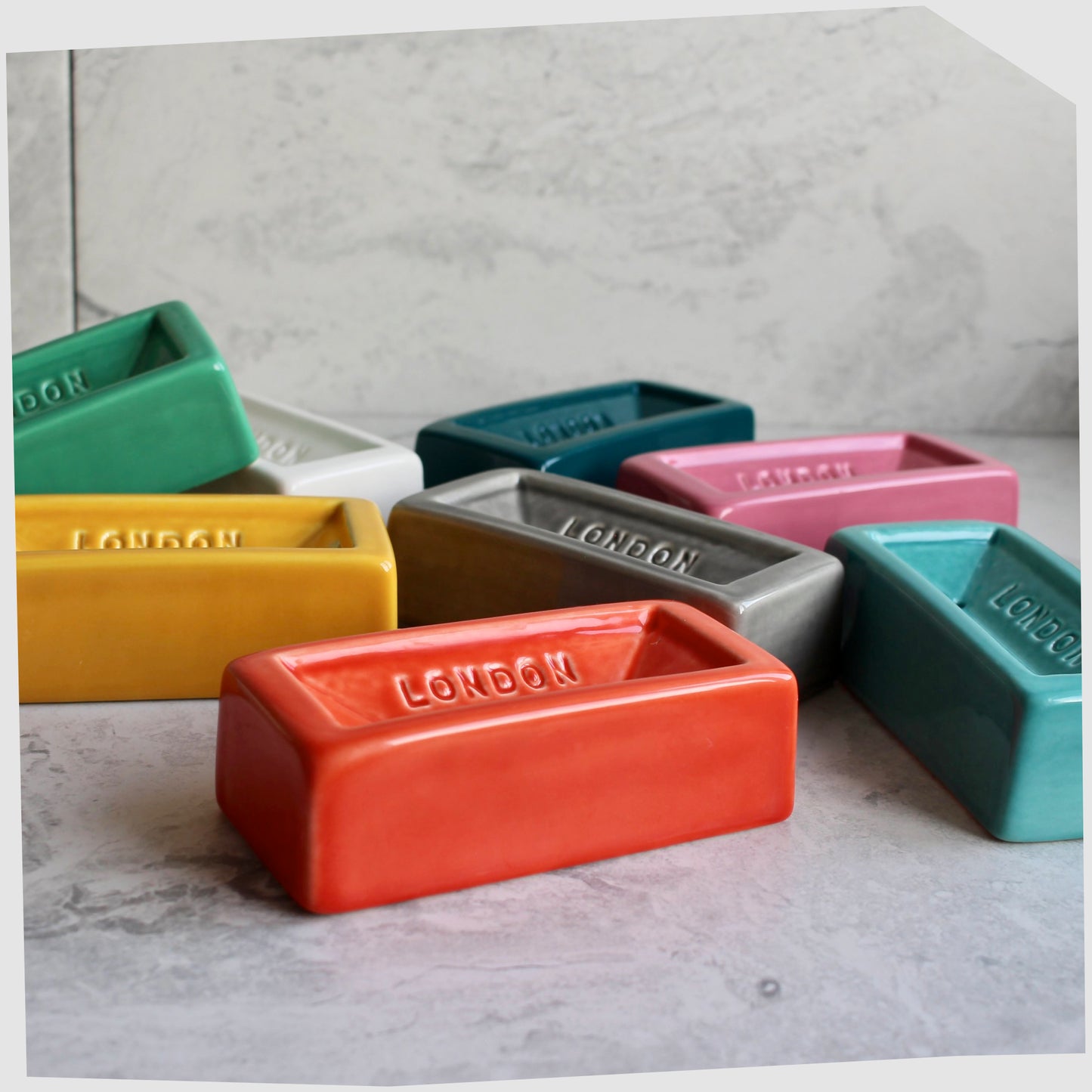 collection-of-london-brick-ceramic-soap-dishes-in-green-yellow-white-grey-orange-teal-pink-and-turquoise