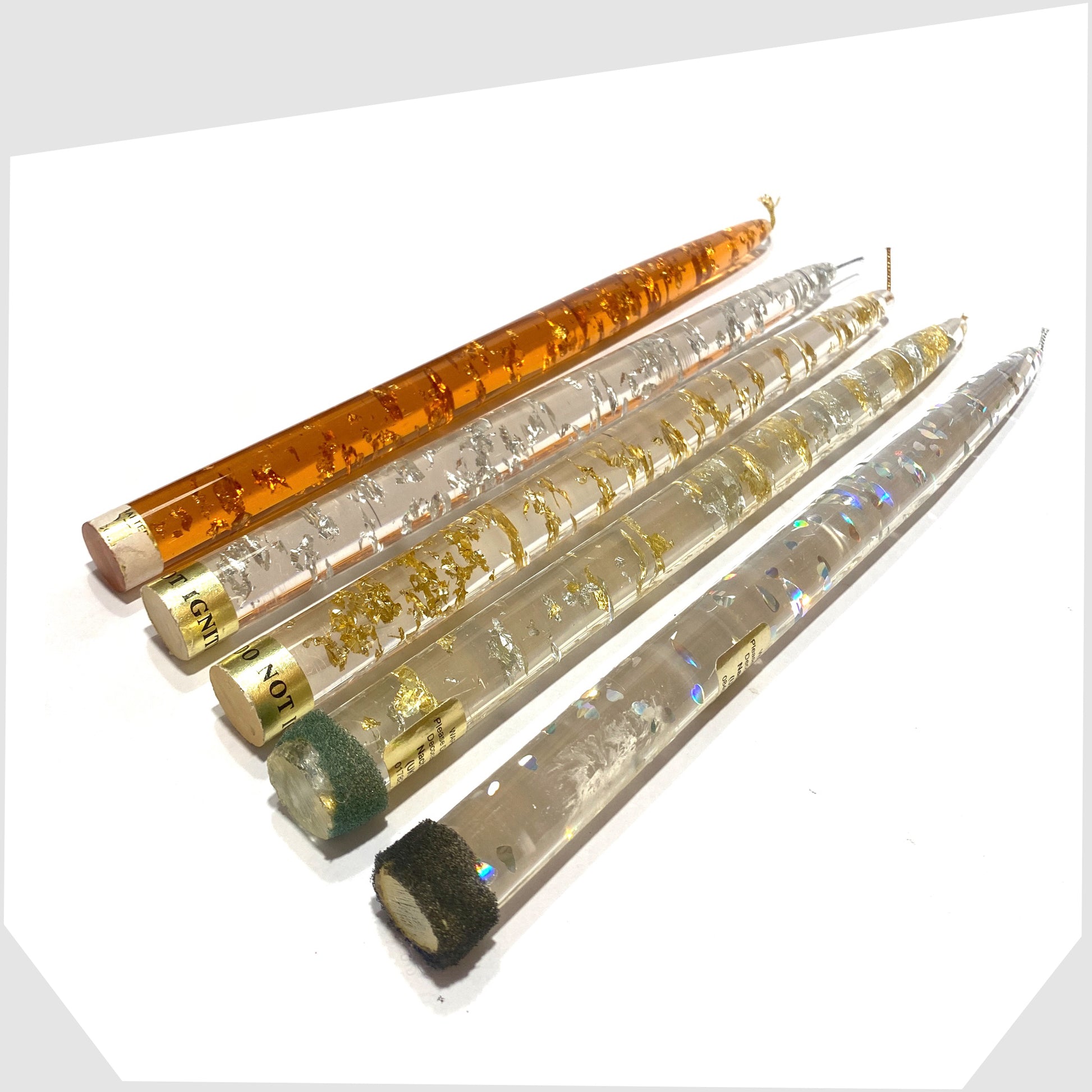 vintage lucite taper candle in clear and orange acrylic with gold and silver flecks