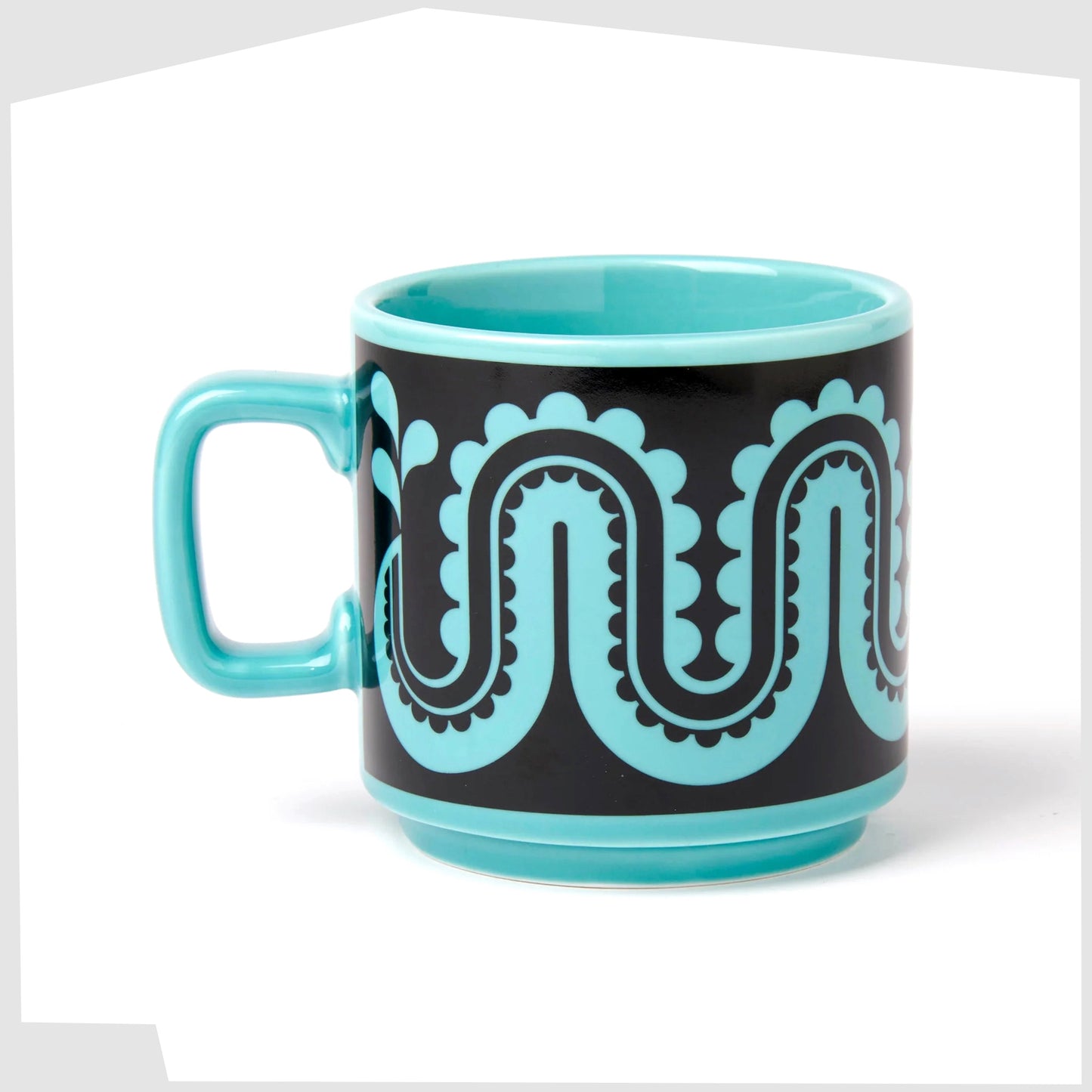 magpie x hornsea pottery nessie mug, blue stoneware mug with a black pattern of a flowing repeating sea monster