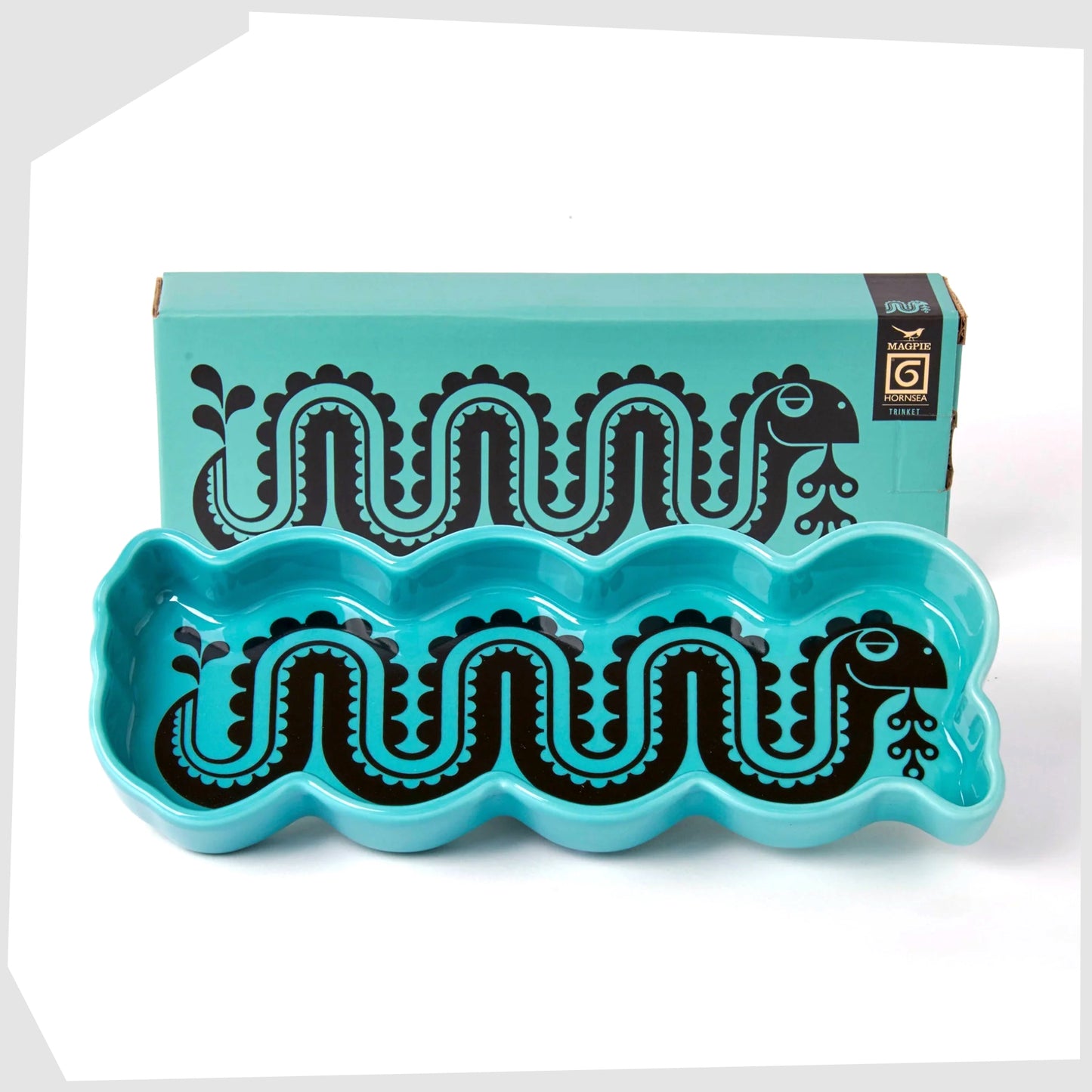 magpie x hornsea pottery Nessie trinket tray, blue ceramic tray with a black sea monster design, shown with its gift box packaging