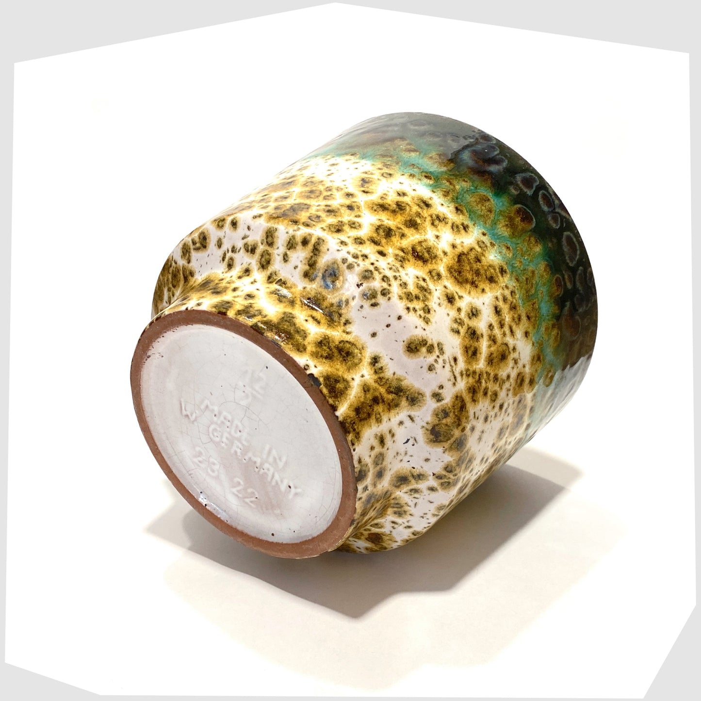 base of the Marei Keramik Planter in fat lava glaze with bands of green and navy glaze