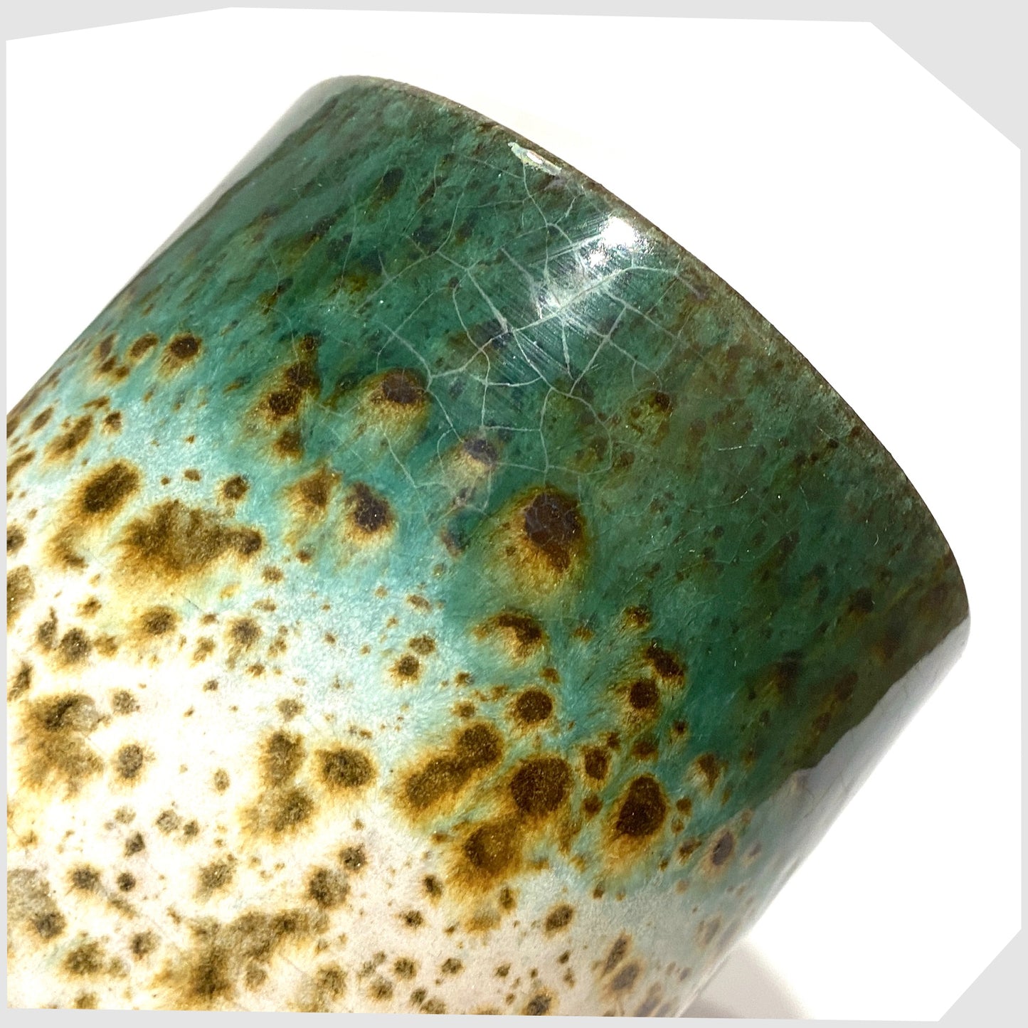 close up of the Marei Keramik Planter in green and white speckled glaze