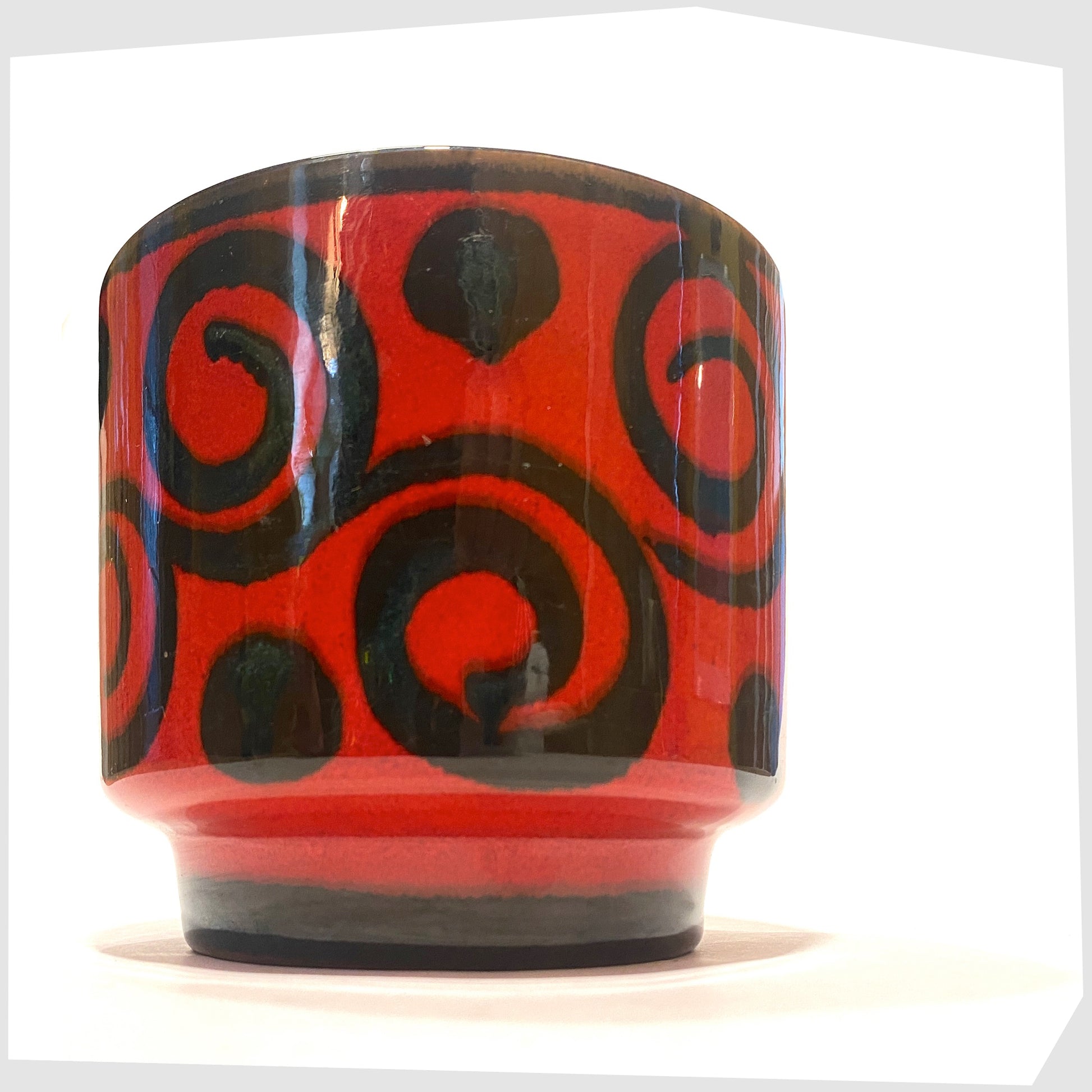 west german pottery plant pot made by marei keramik, in a vivid red glaze with black swirling lines