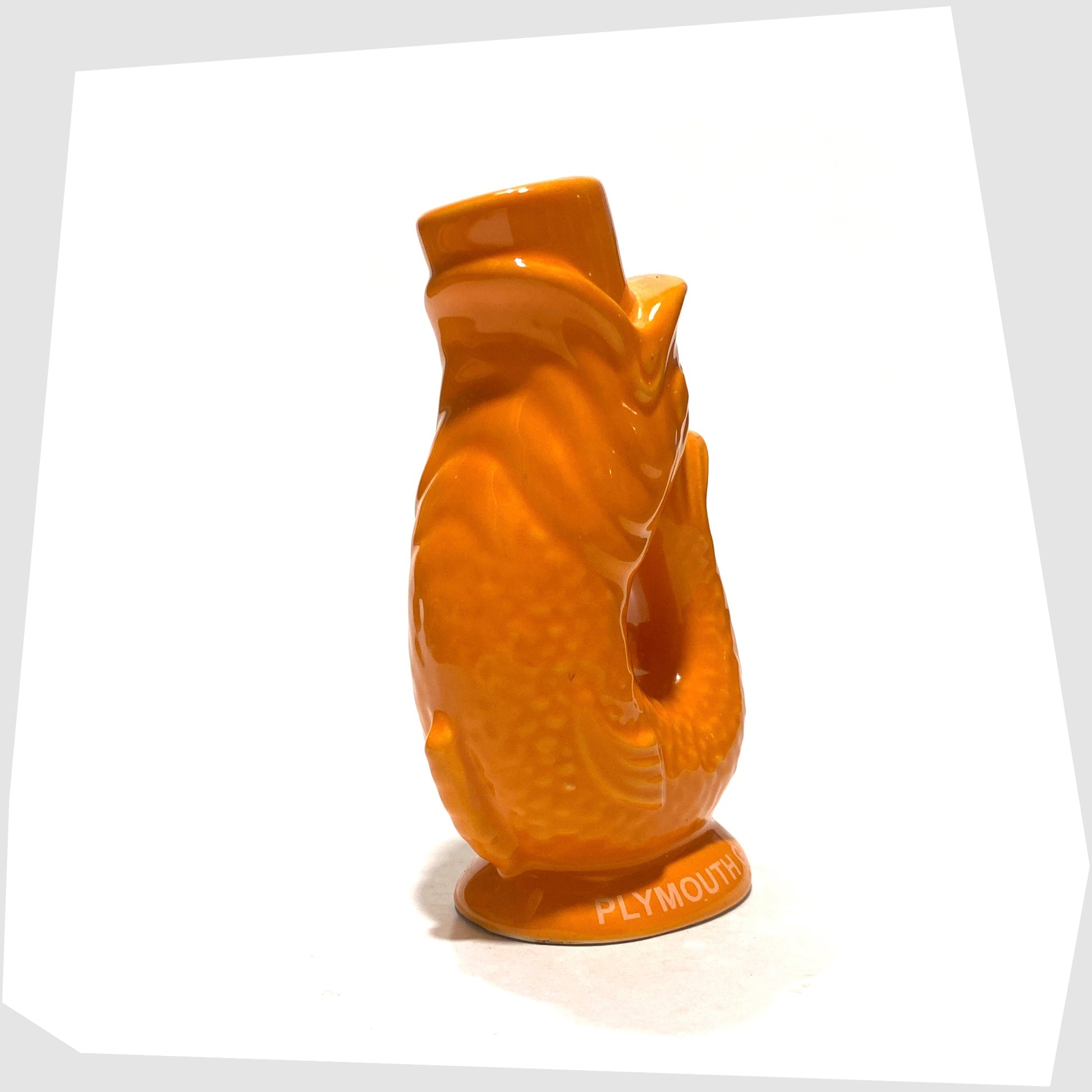 front of the mini gluggle jug in orange glaze with plymouth gin text around the base rim