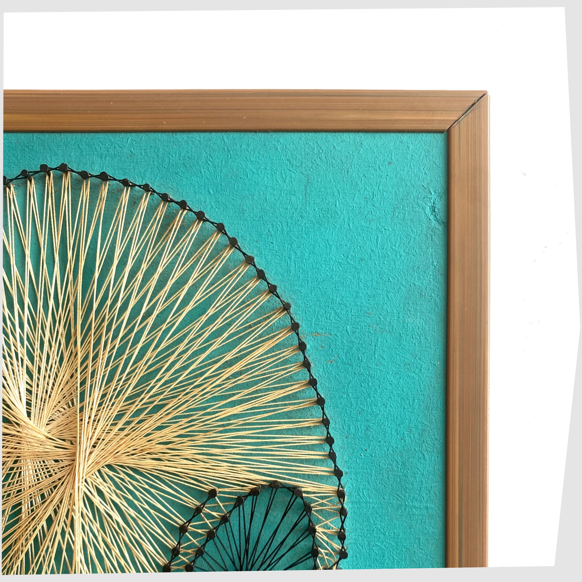 Close up of the 1960s Vintage Snoopy String Artwork, created from beige string and black nails on a teal background, shown on a white background