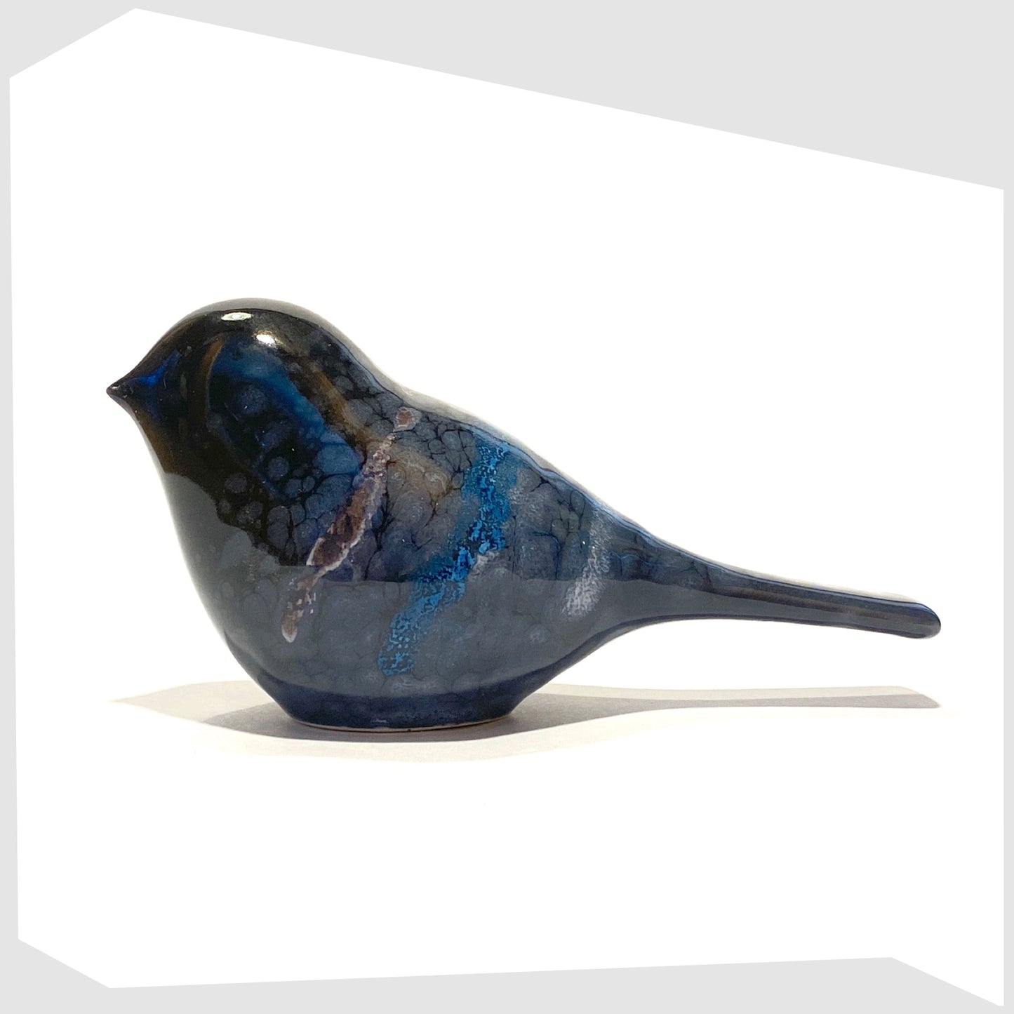 poole pottery bird ornament in celestial glaze of black with blue and purple tones