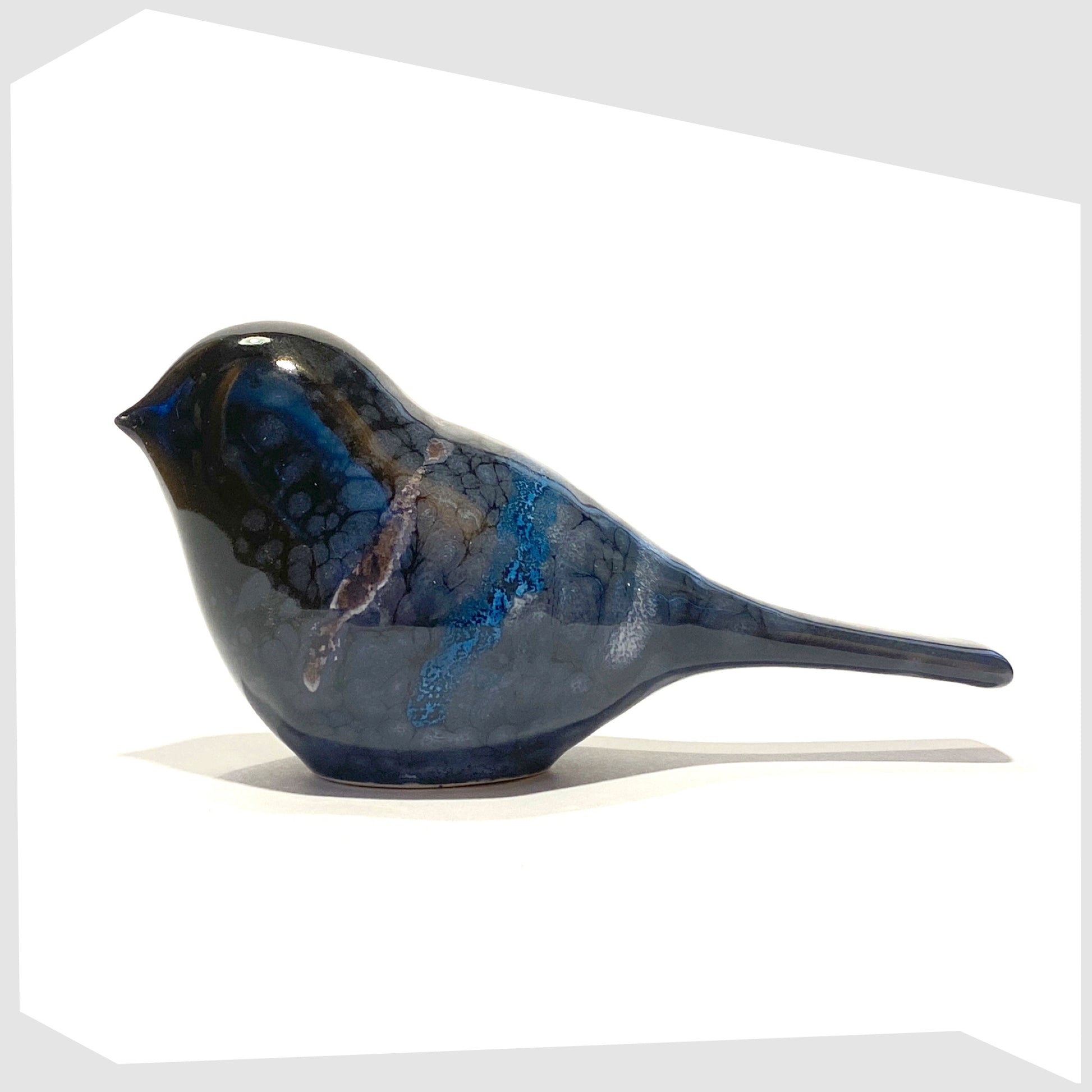 poole pottery bird ornament in celestial glaze of black with blue and purple tones