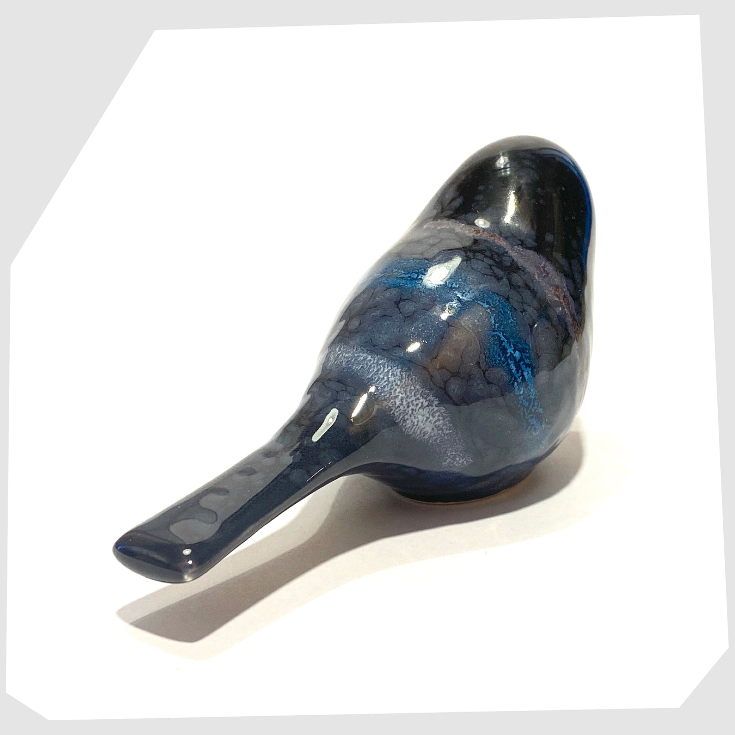 rear of the poole pottery ceramic bird ornament in celestial glaze of black with blue and purple tones