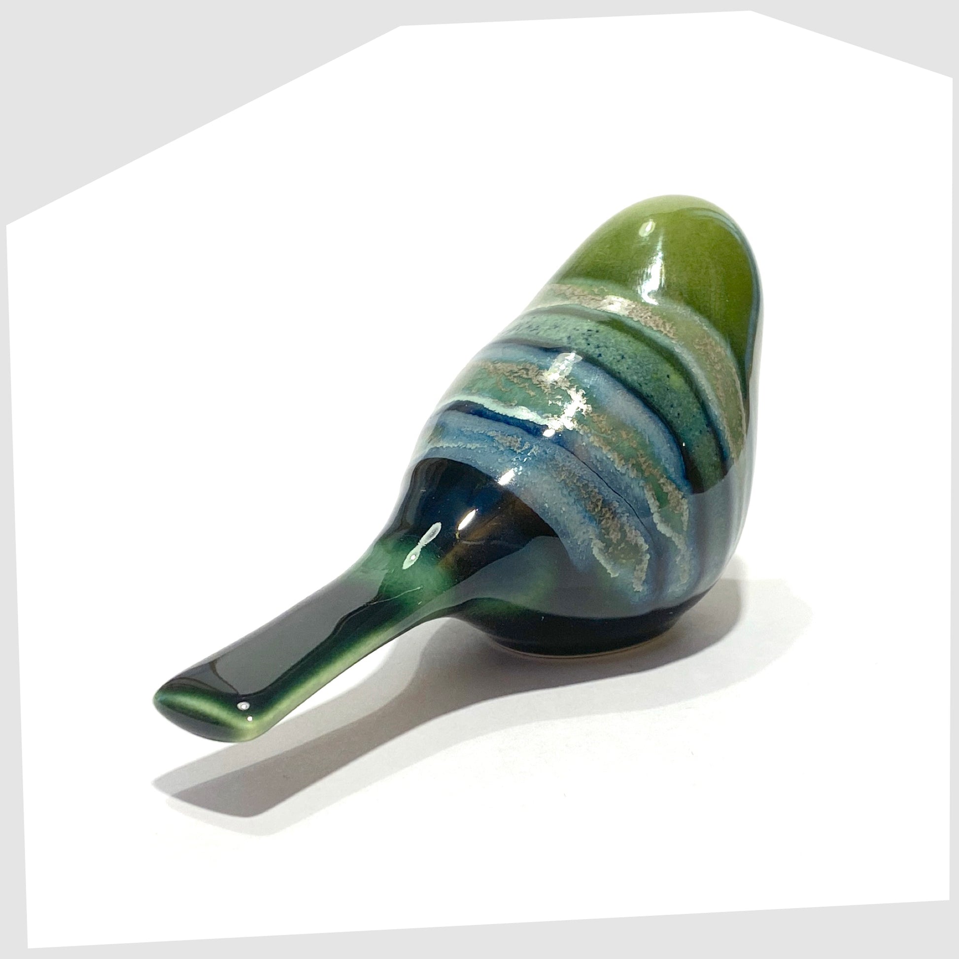 rear of the poole pottery perching bird ornament in maya glaze of green, blue and warm grey