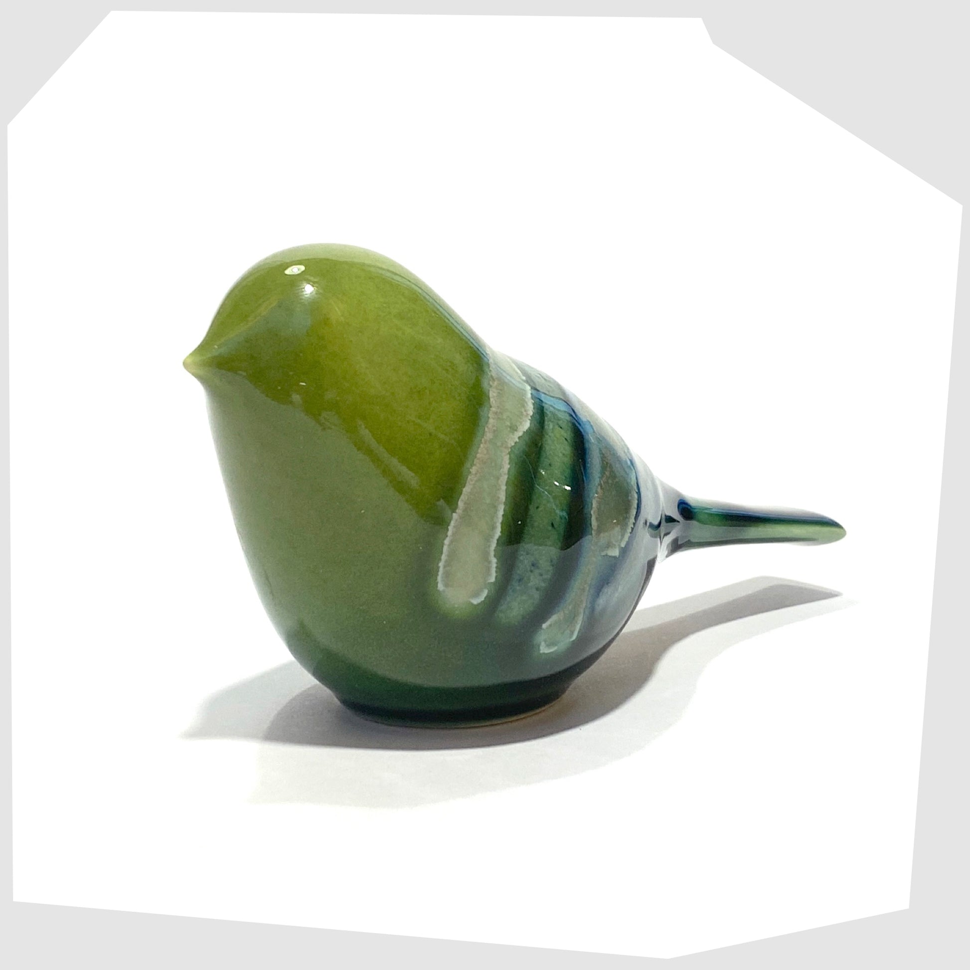 front of the poole pottery perching bird ornament in maya glaze of green, blue and warm grey