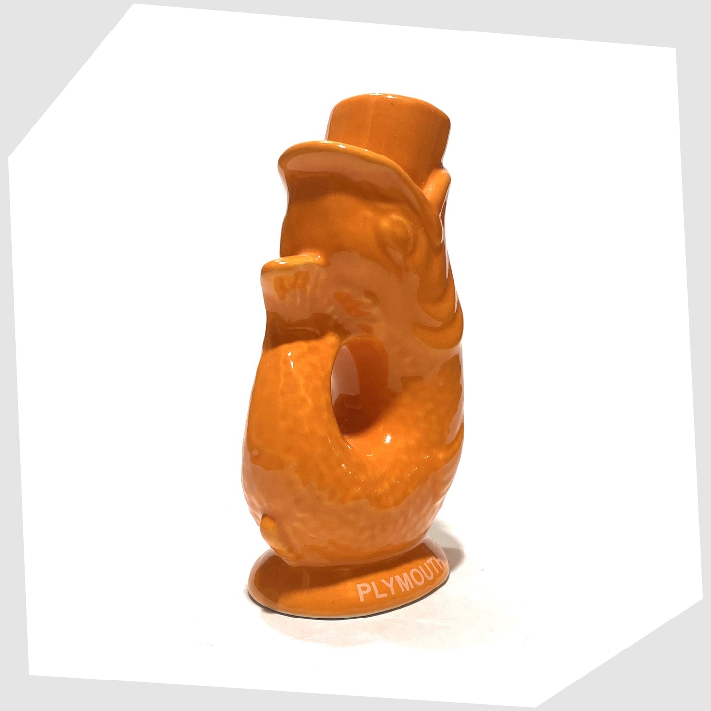 tail of the mini gluggle jug in orange glaze with plymouth gin text around the base rim