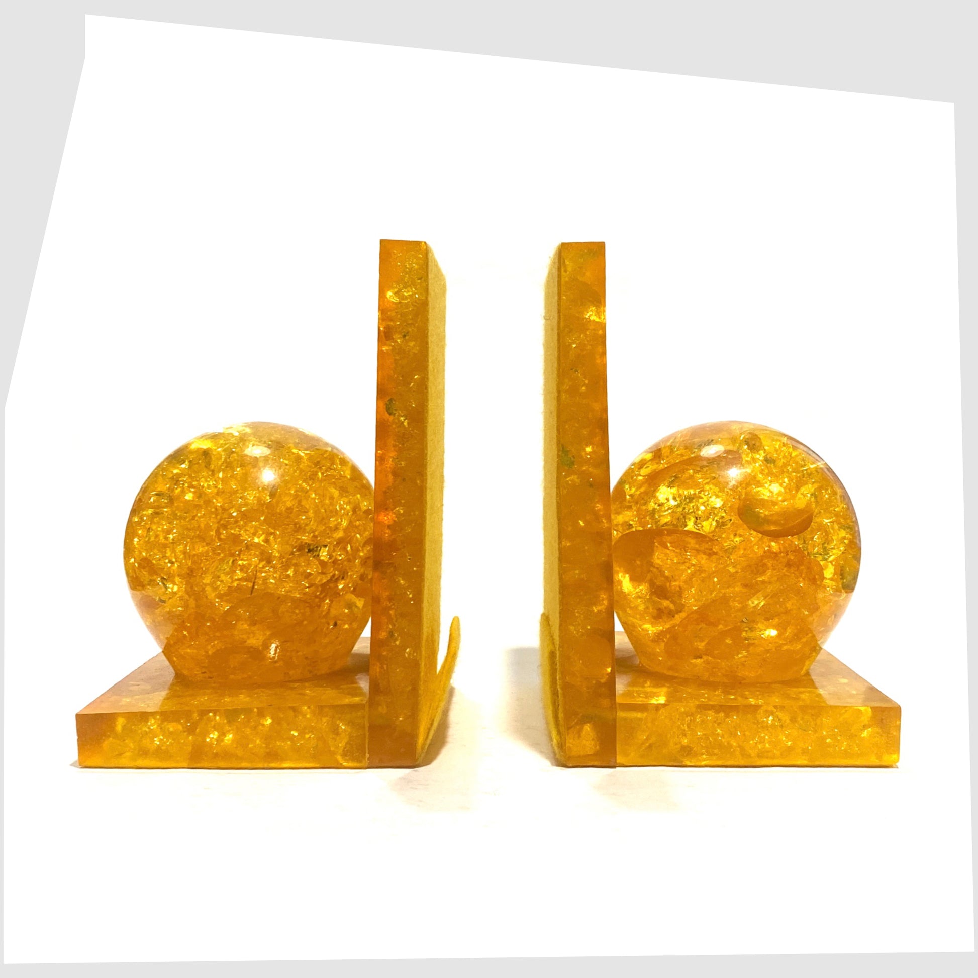 Pair of mid-century modern Shattaline Bookends in orange resin shown without books