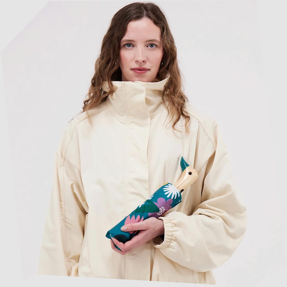 Lifestyle image of the Original Duckhead Umbrella in Bloom print, shown folded in a woman's hand