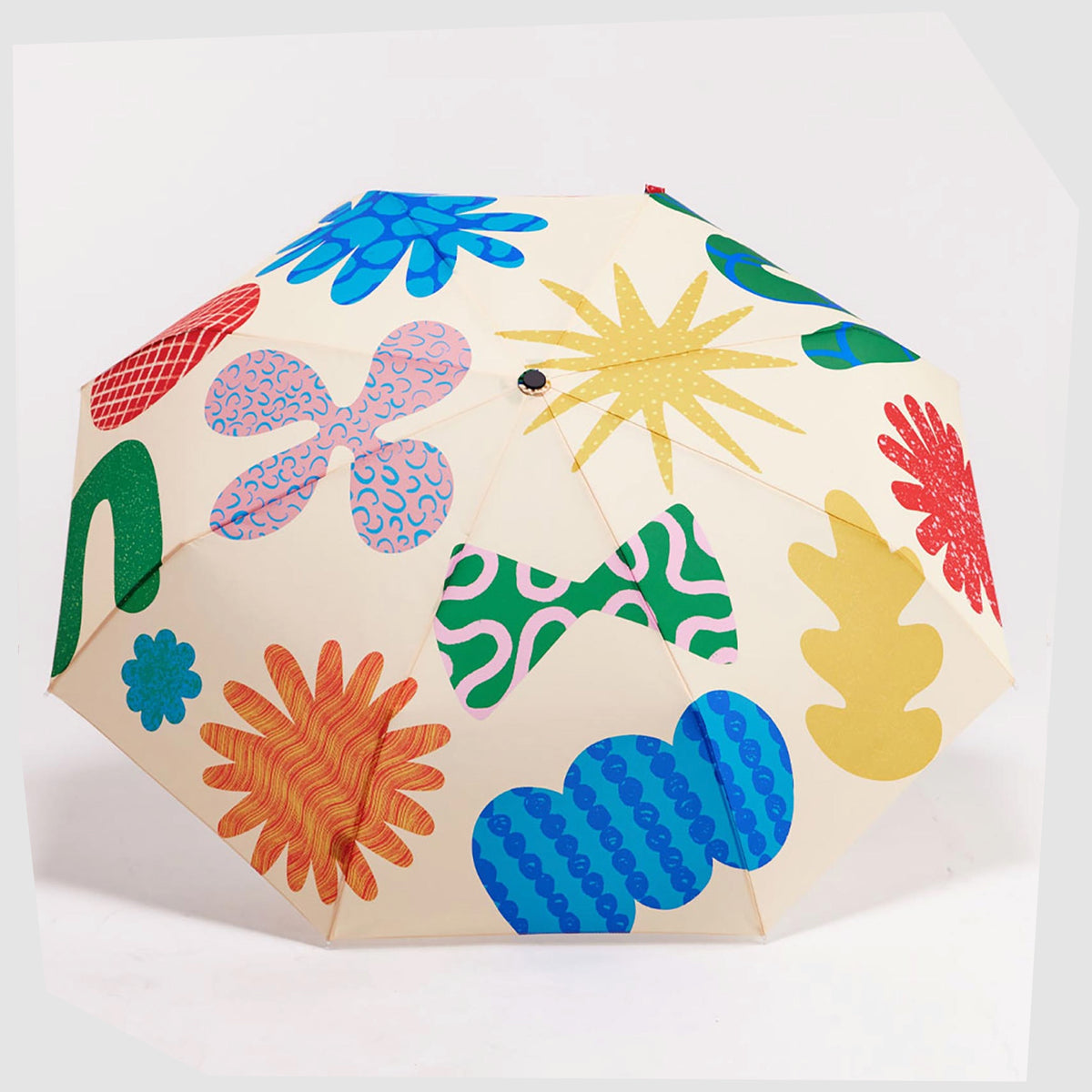 Canopy of the Original Duckhead Umbrella in Deli pattern of multicoloured abstract forms on a beige fabric, shown open on a white background