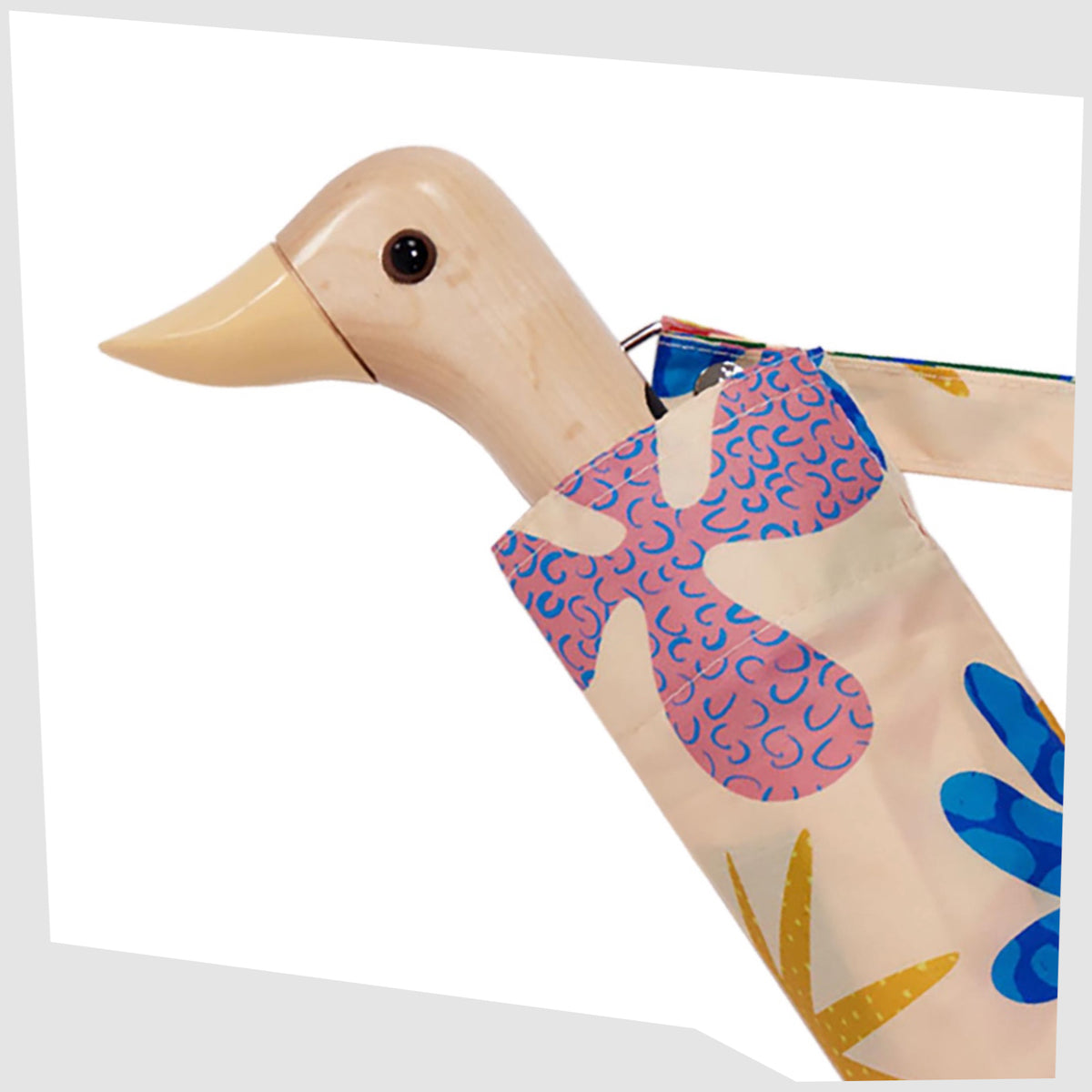 Close up of the birchwood duck-shaped handle of the Original Duckhead Umbrella in Deli pattern, shown on a white background