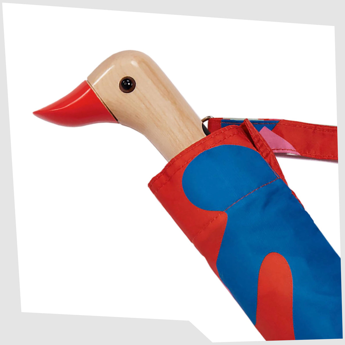 Close up of the birchwood duck-shaped handle of the Salsa Original Duckhead Umbrella, shown on a white background