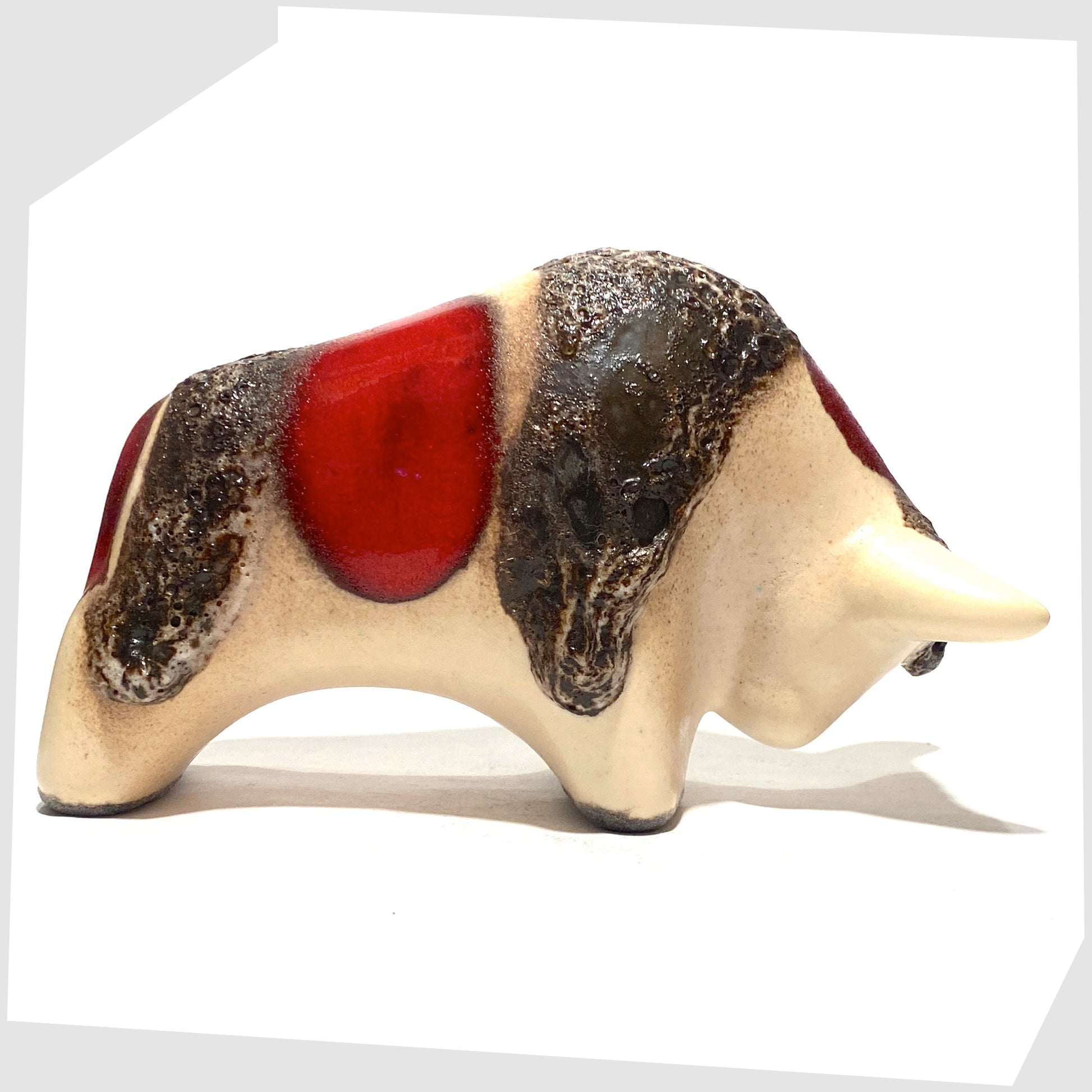 hand-crafted otto keramik ceramic bull shaped ornament in the red garnet glaze with stripes of deep fat lava