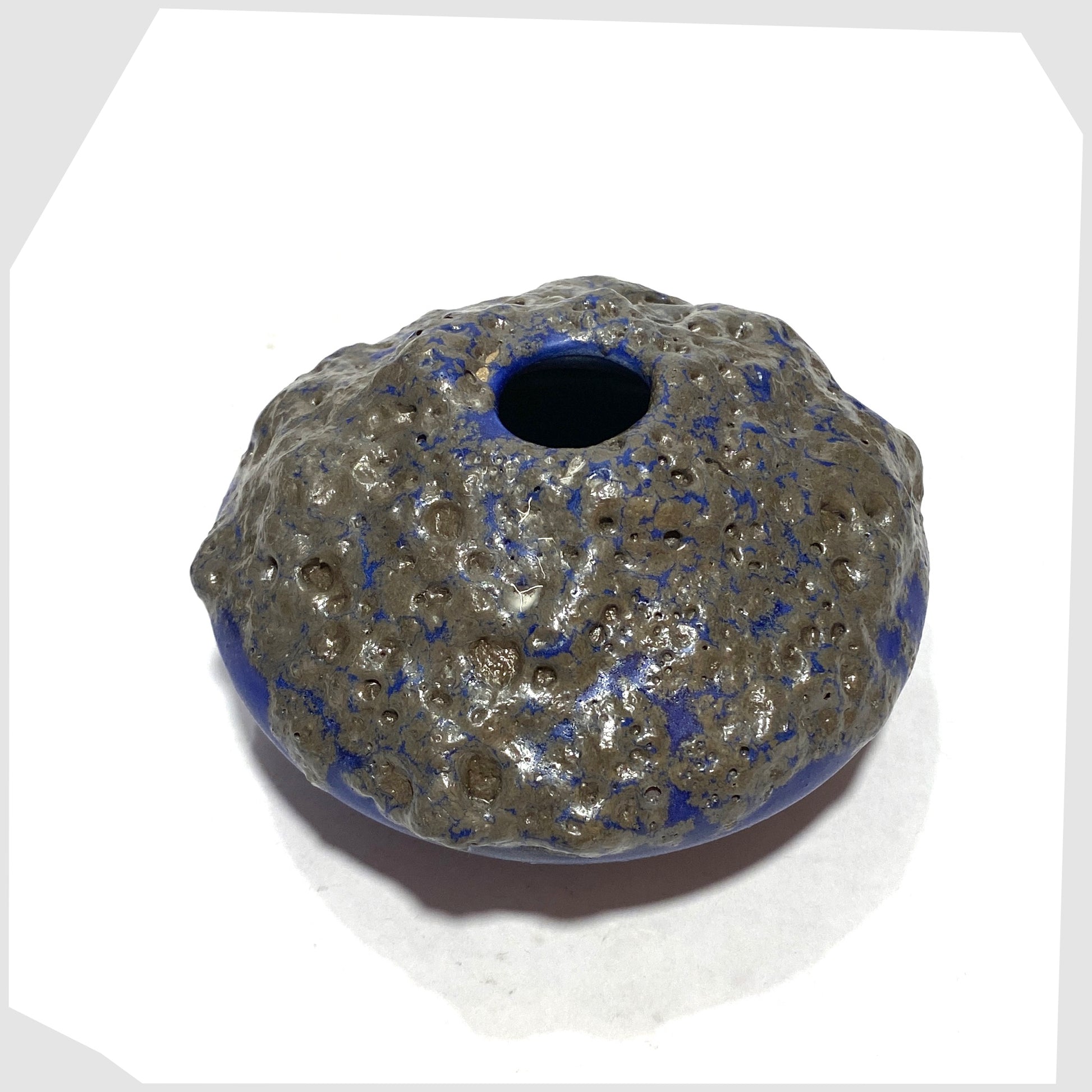 Overhead view of the Otto Keramik 203 Vase in blue glaze with grey fat lava glazing, shown on a white background