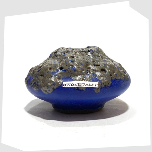 Otto Keramik 203 Vase in blue glaze withgrey fat lava glazing, shown with the Otto Keramik label attached, shown on a whitebackground