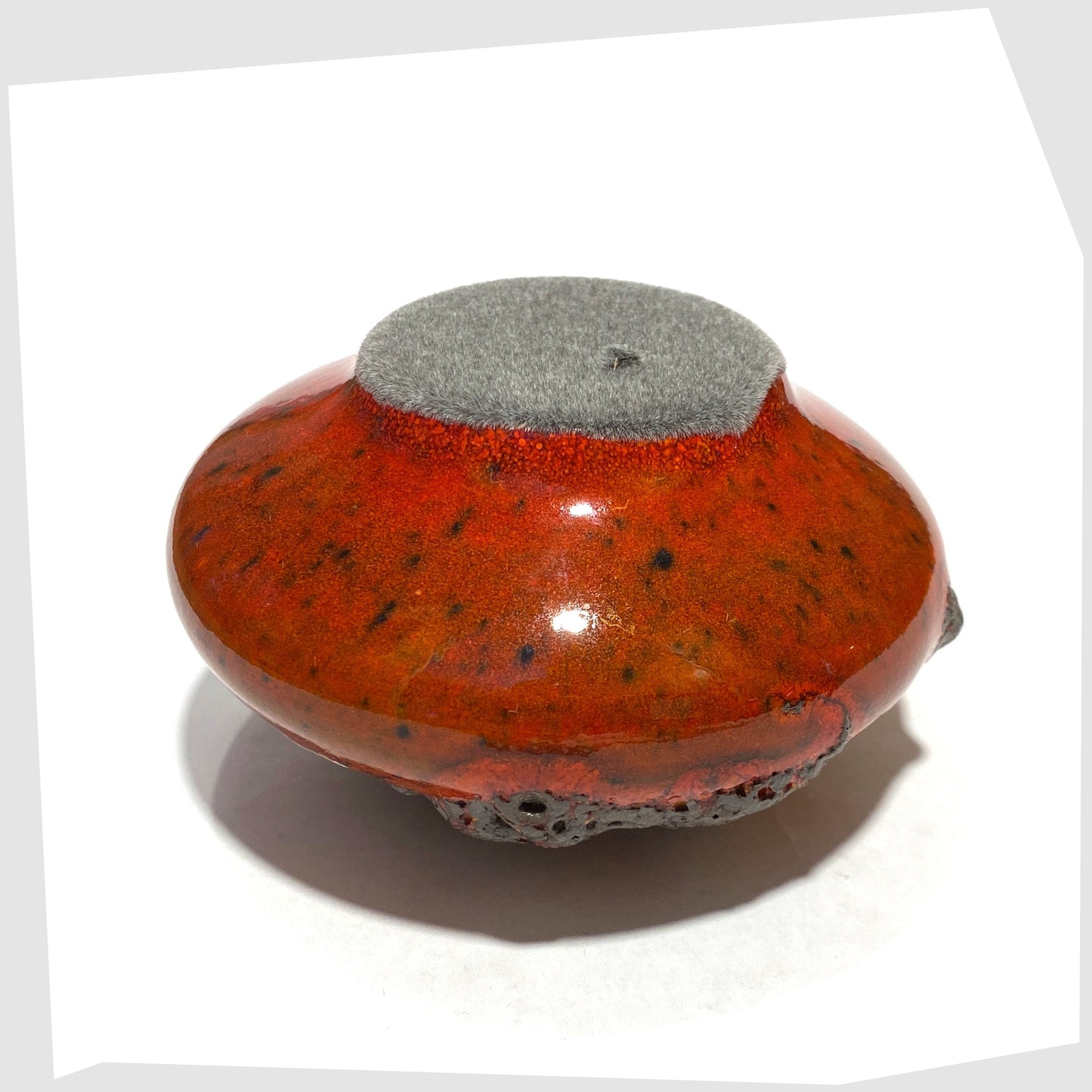 Felted base of the Otto Keramik 203 Vase in red glaze with yellow around the top rim, shown on a white background