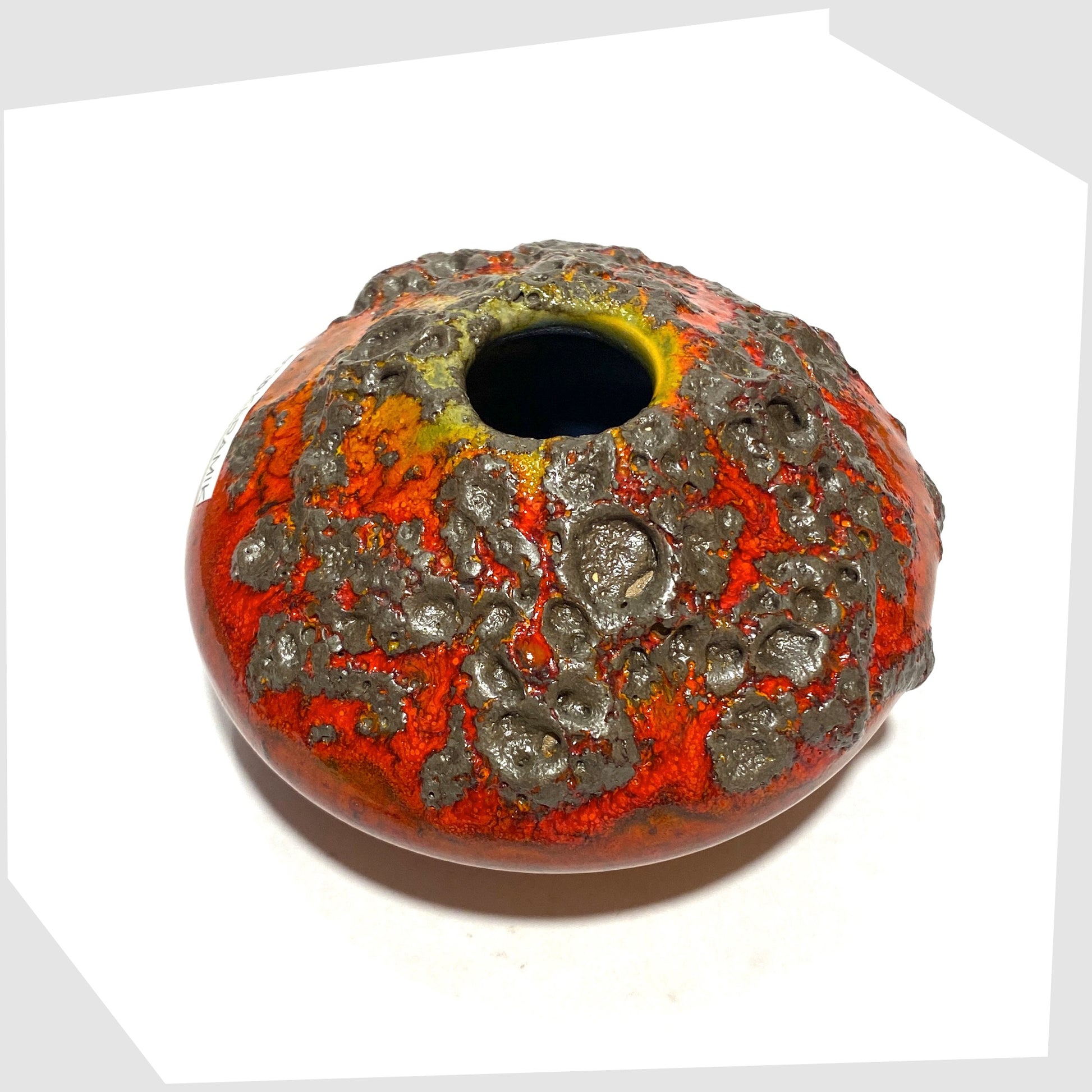 Overhead view of the Otto Keramik 203 Vase in red glaze with yellow around the top rim, shown on a white background