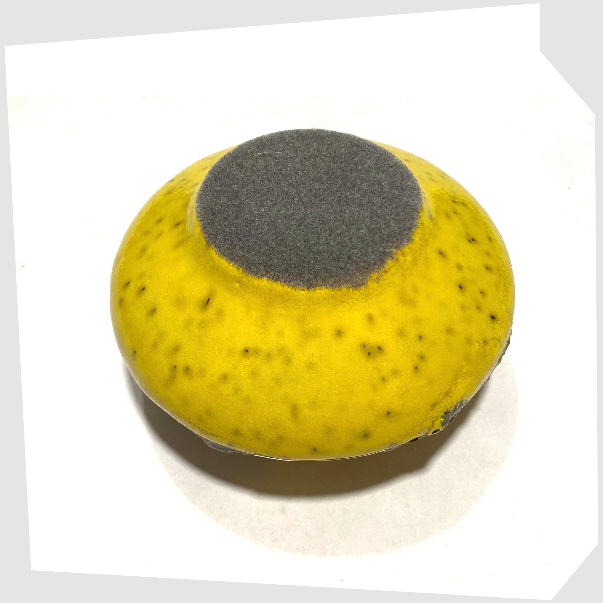 Felted base of the Otto Keramik 203 Vase in yellow with grey fat lava glaze, shown on a white background