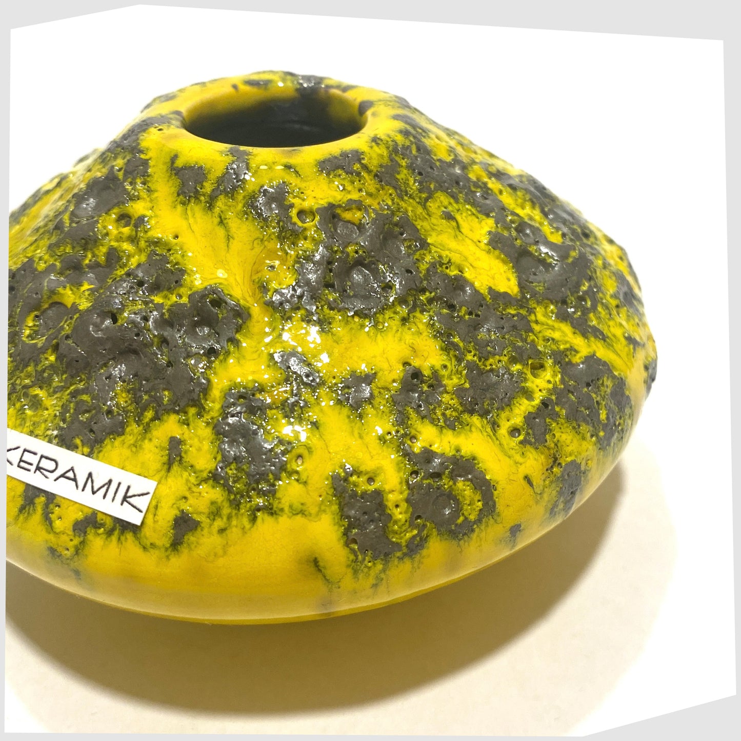 Close up of the Otto Keramik 203S Vase in Yellow with grey fat lava glaze