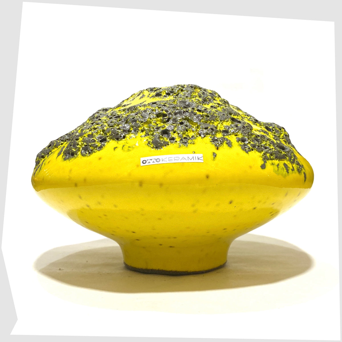 Side of the Otto Keramik Vase, model 203, in vibrant yellow glaze with grey fat lava, shown on a white background