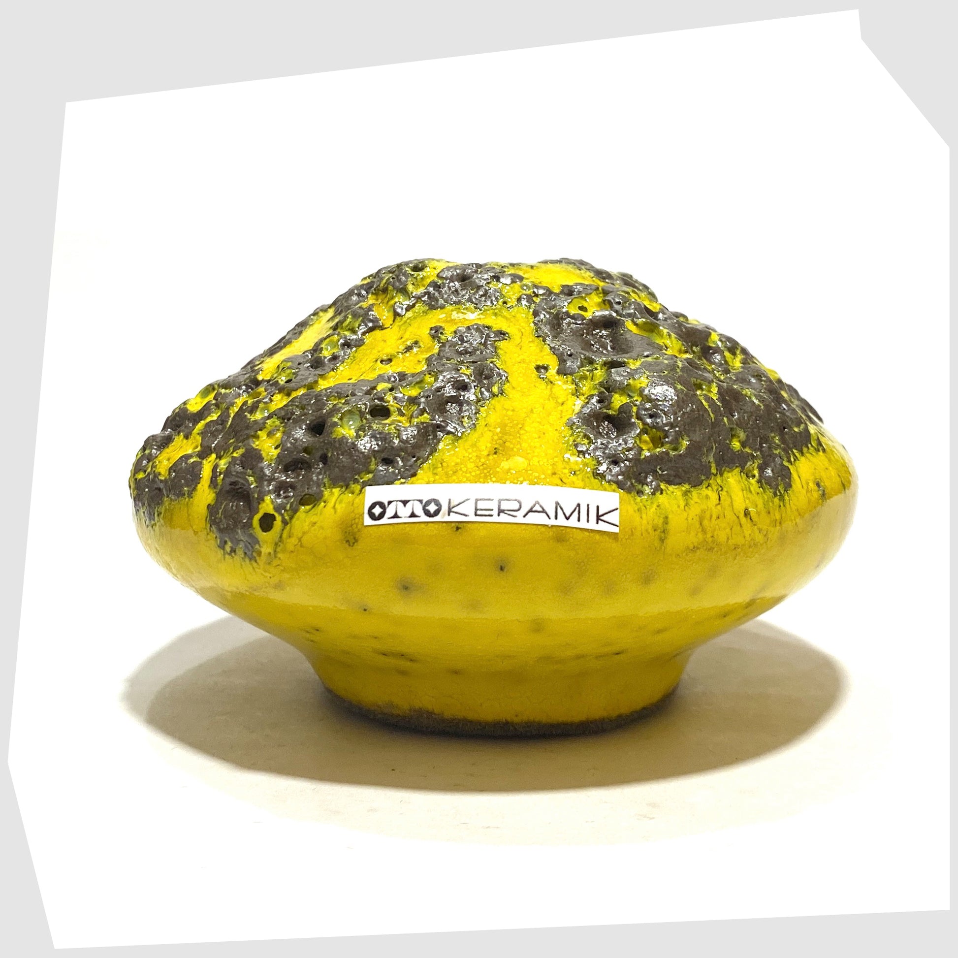 Otto Keramik 203 Vase in yellow with grey fat lava glaze, shown with the otto keramik sticker on a white background