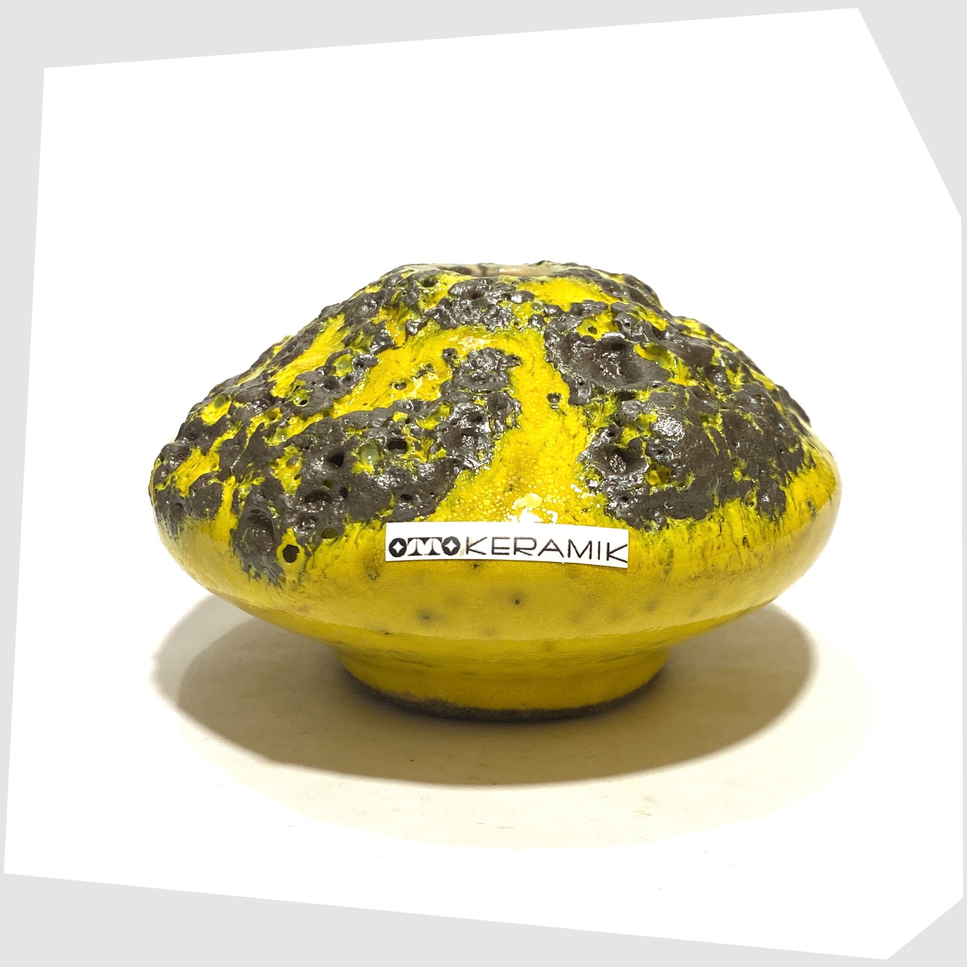 Small Otto Keramik 203 Vase in yellow with grey fat lava glaze, shown with the otto keramik sticker on a white background