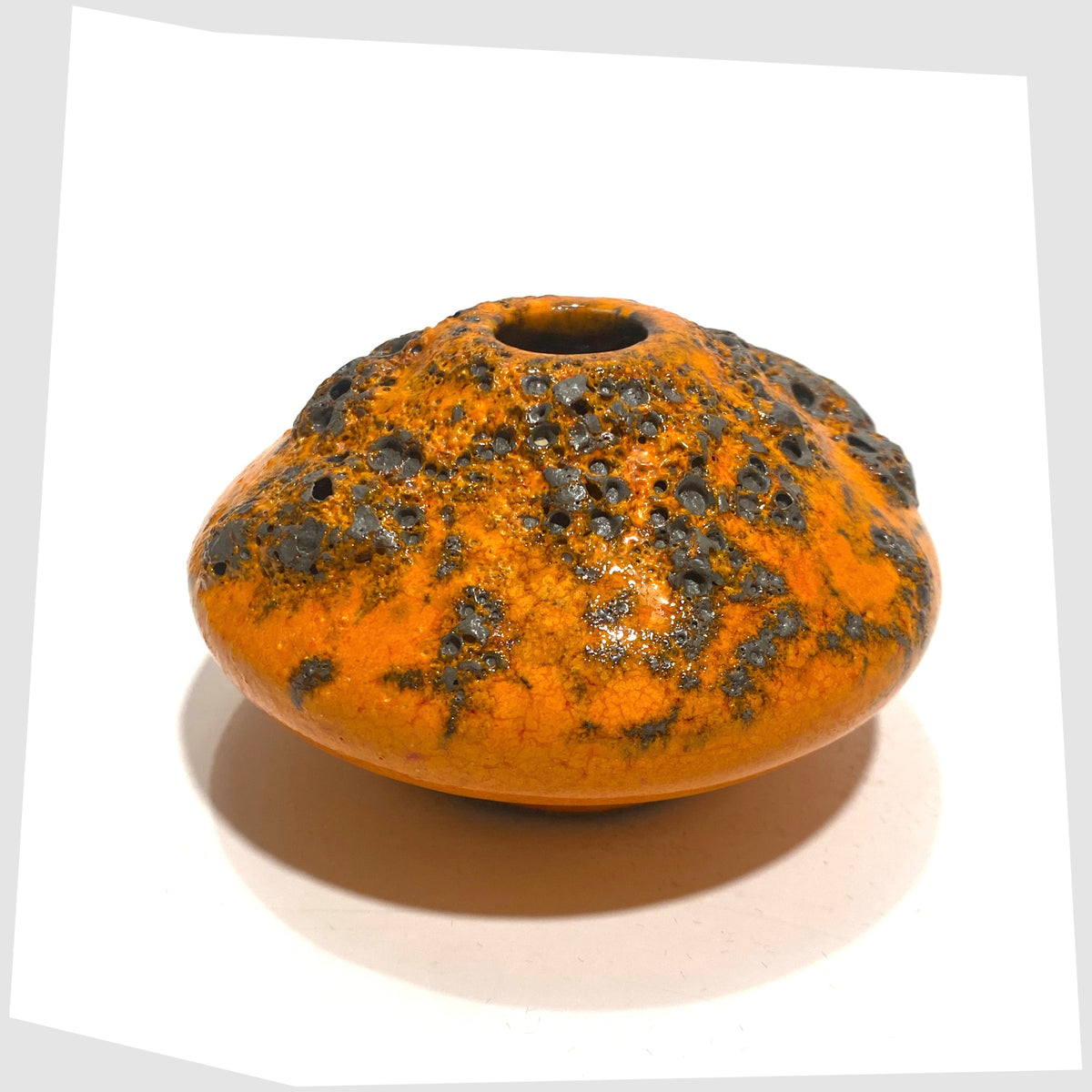 Reverse angle of the Otto Keramik Vase, model 203s, in orange glaze with grey fat lava, shown on a white background