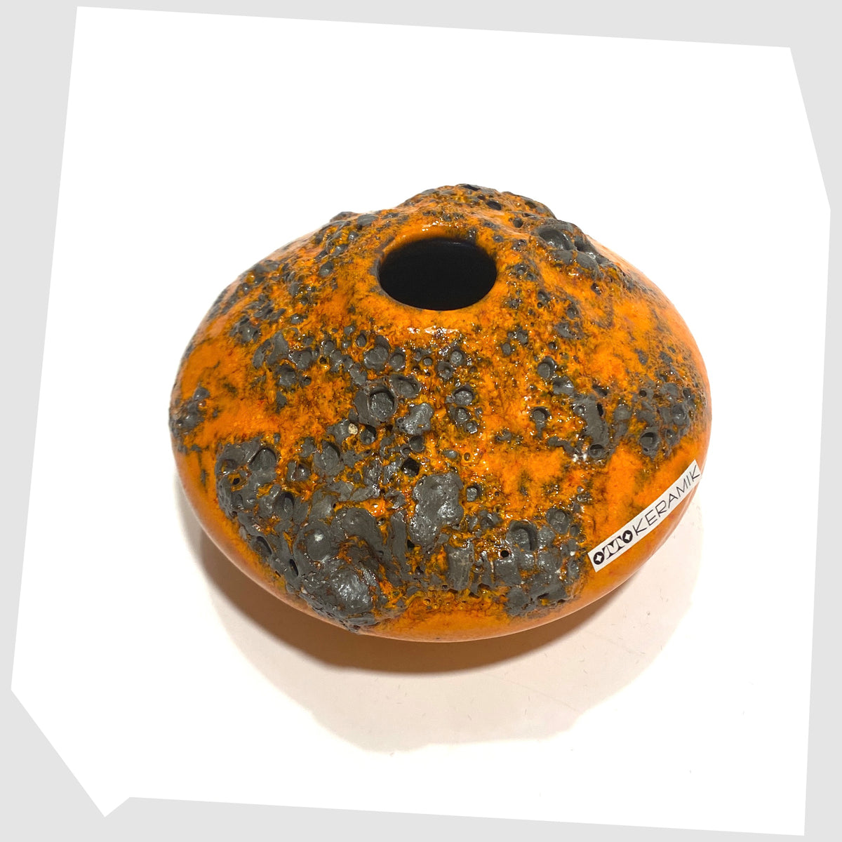 Overhead view of the Otto Keramik Vase, model 203s, in orange glaze with grey fat lava, shown on a white background