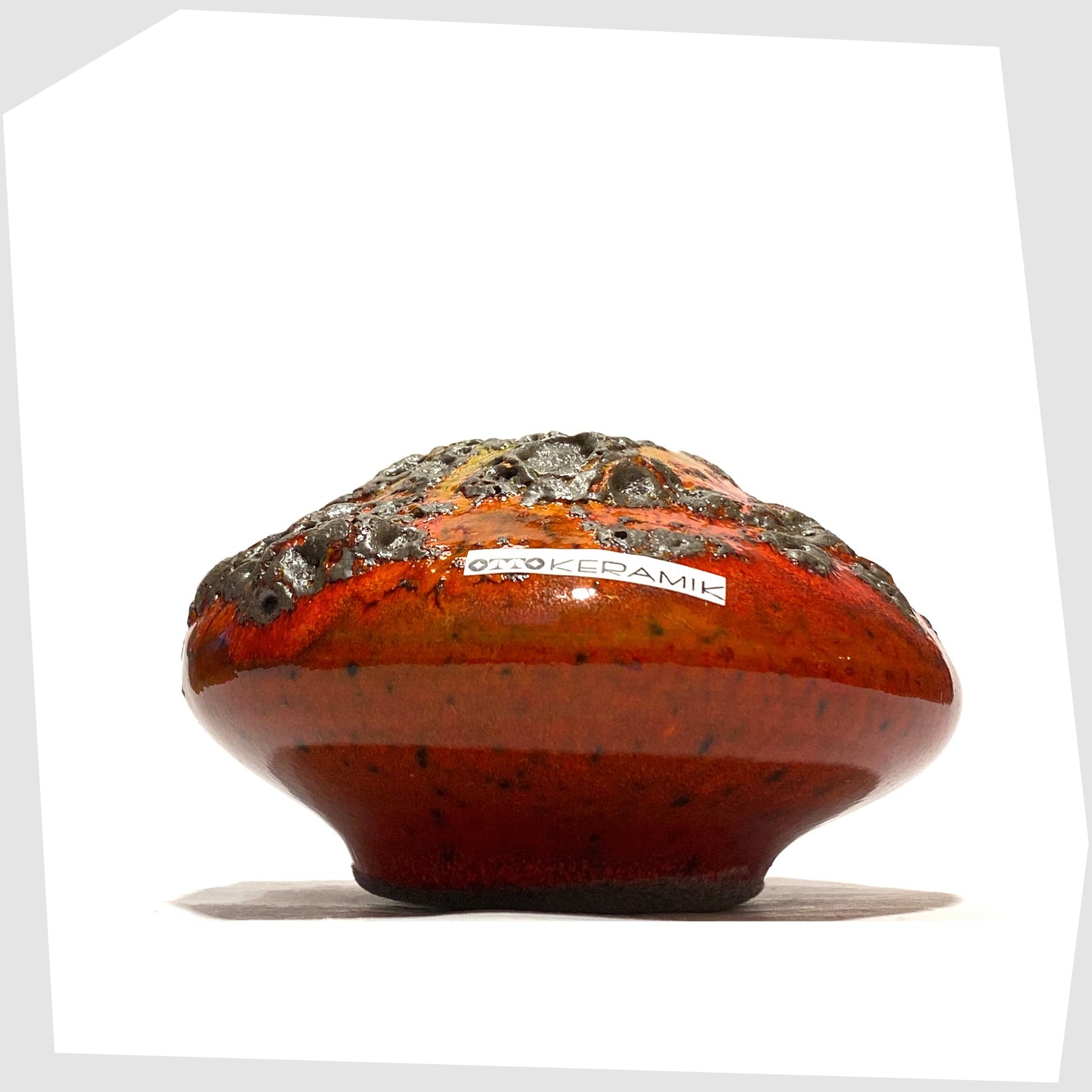 Compact Otto Keramik 203 Vase in red glaze with yellow around the top rim, shown on a white background