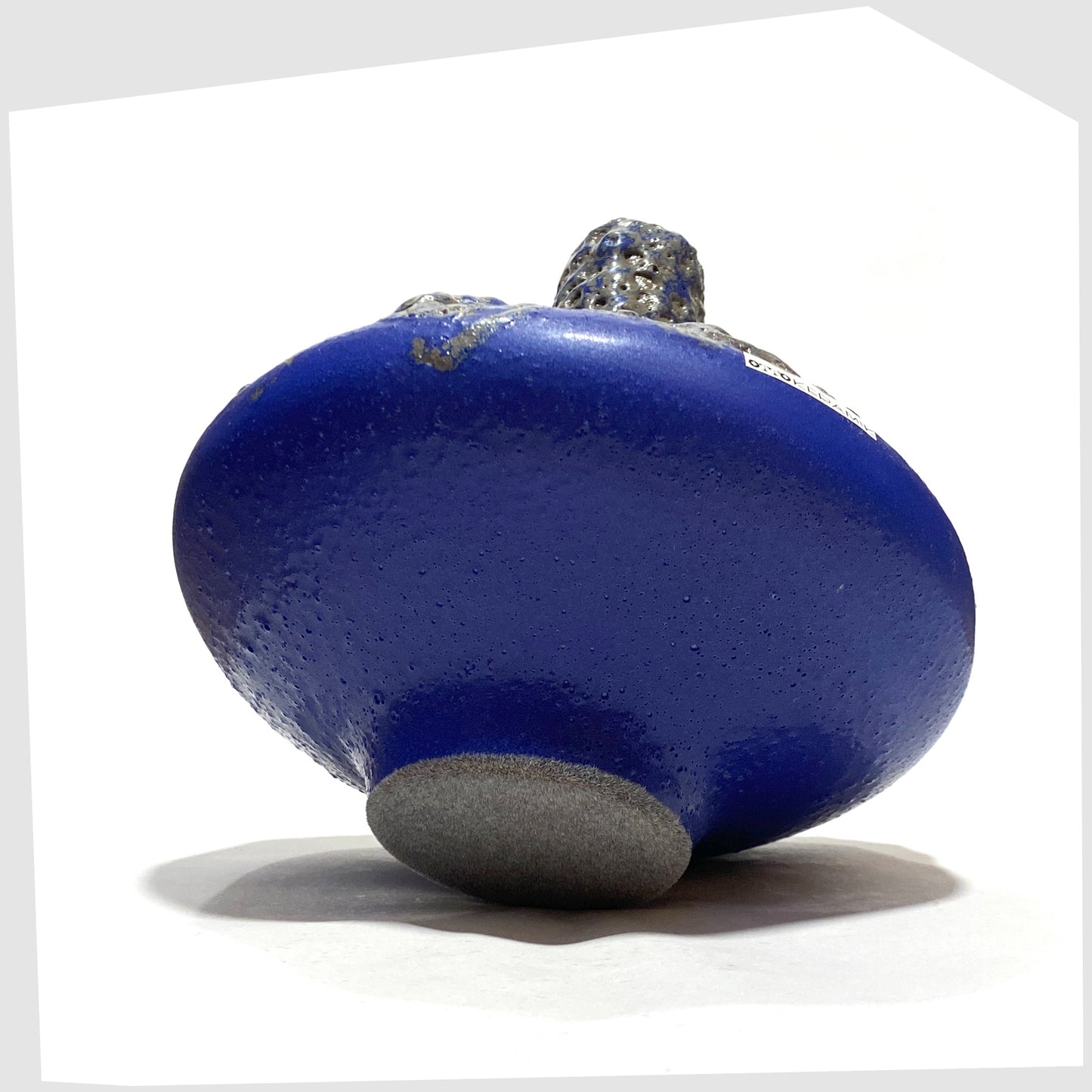 Felted base of the Otto Keramik 206 Vase in a vivid blue colour with grey fat lava glaze, shown on a white background