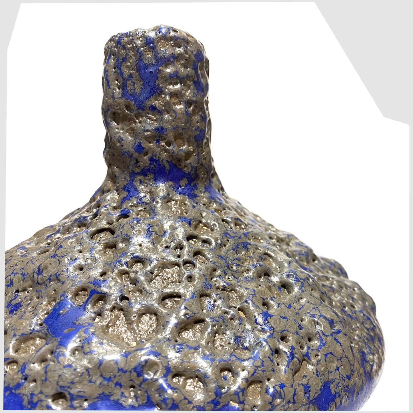 Close up of the Otto Keramik 206 Vase in a vivid blue colour with grey fat lava glaze, shown on a white background