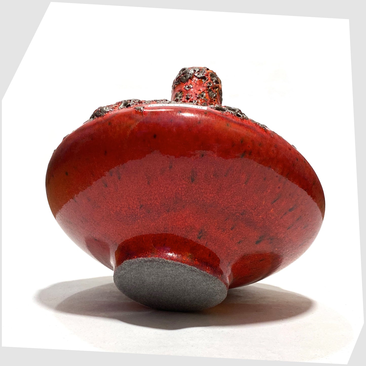 Felted base of the Otto Keramik 206 Vase in a rich red glaze with yellow hues around the rim and deep fat lava glazing, shown on a white background