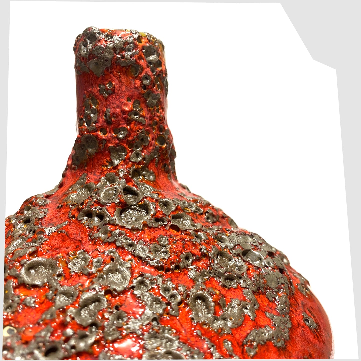 Close up of the Otto Keramik 206 Vase in a rich red glaze with yellow hues around the rim and deep fat lava glazing, shown on a white background