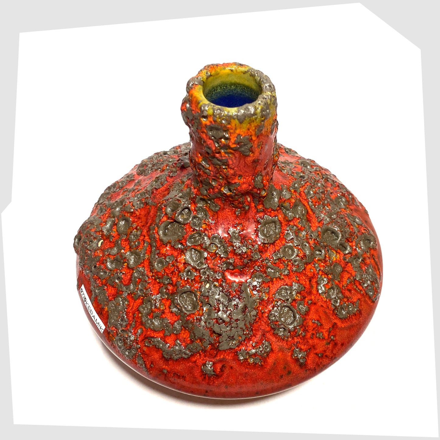 Overhead view of the Otto Keramik 206 Vase in a rich red glaze with yellow hues around the rim and deep fat lava glazing, shown on a white background
